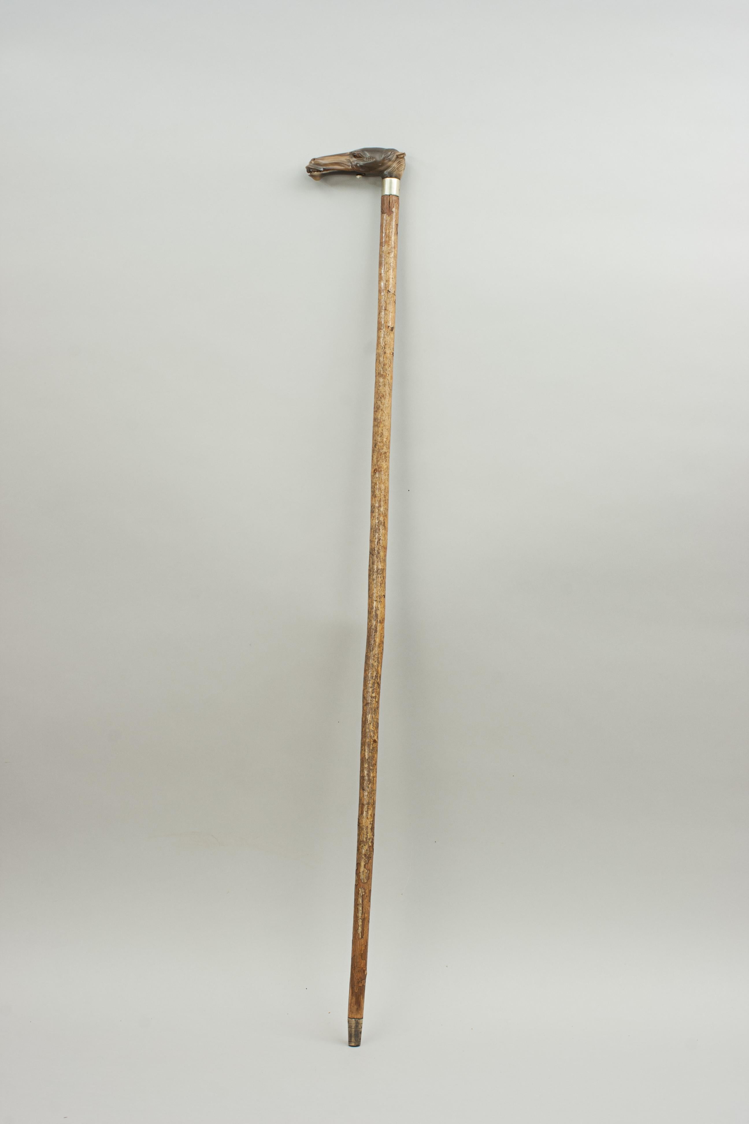 Automaton horse head walking cane.
Early 20th century walking stick with an automaton horse head glove holder. The handle is carved from Horn, finely detailed, having inset glass eyes and spring-loaded opening mouth. The head mounted on wooden