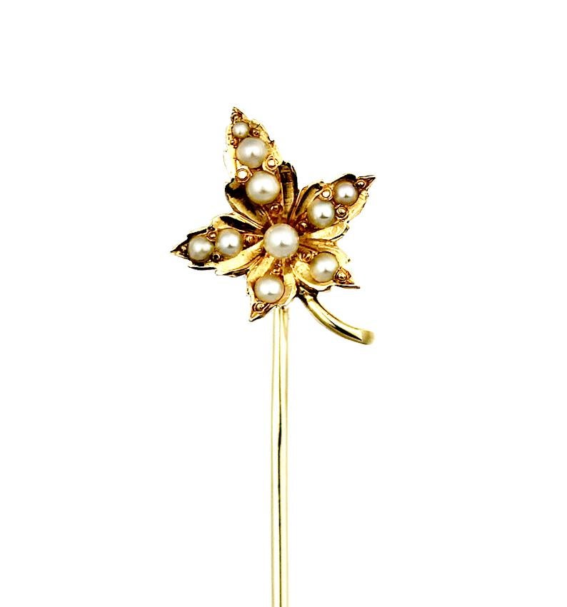 Maple leaf design antique 14/15 carat yellow gold pin in the shape of a five corner leaf, detailed down to the ridges, edge, and stem. The leaf itself is 3 dimensional with the edges folding outwards, the center of the leaf is scattered with small