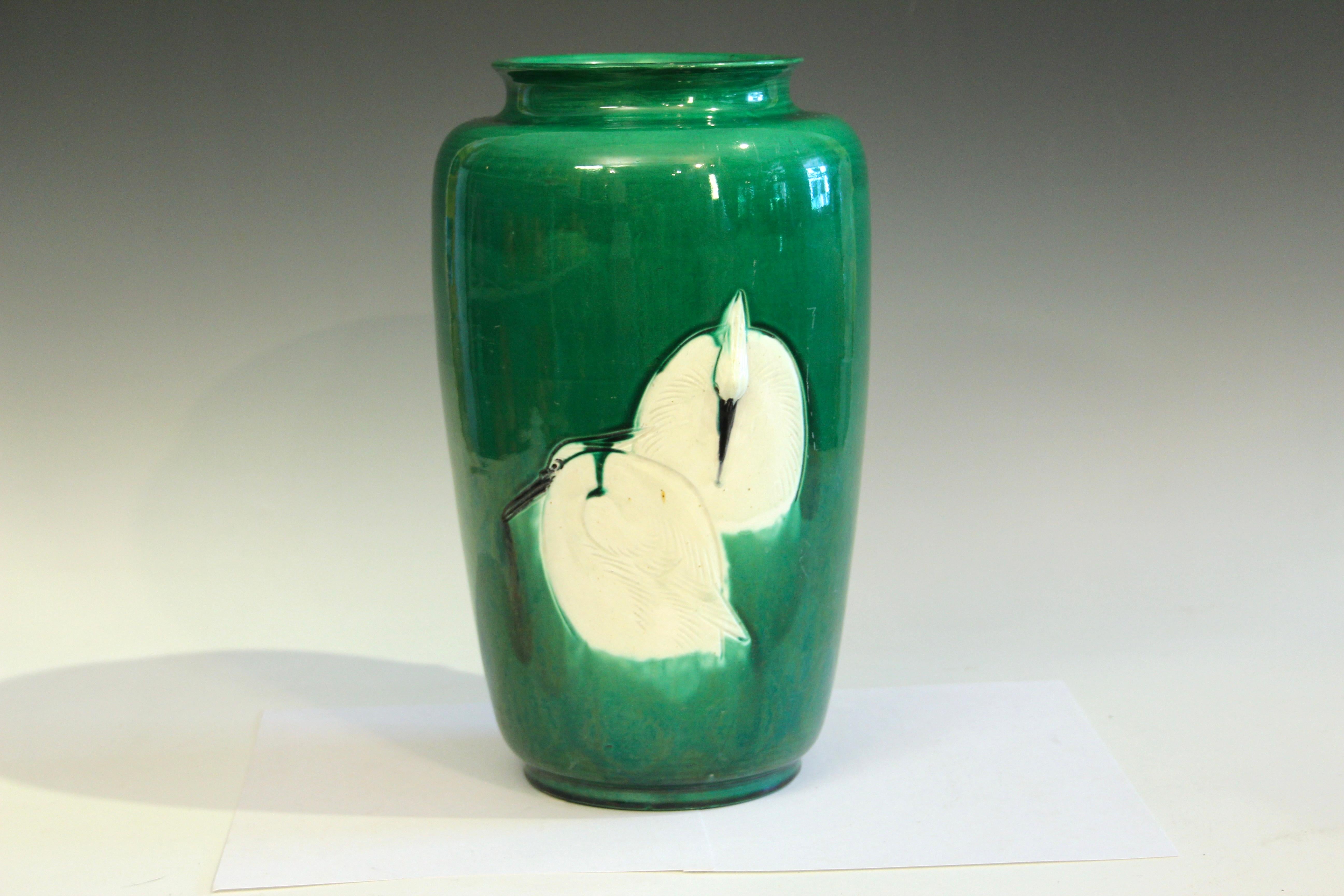 Large antique Awaji pottery Arts and Crafts vase in well balanced form with five cranes, three on the front, and two more on the reverse, circa 1920. The white cranes stand out in contrast to the beautifully rich green ground. Hand turned. The