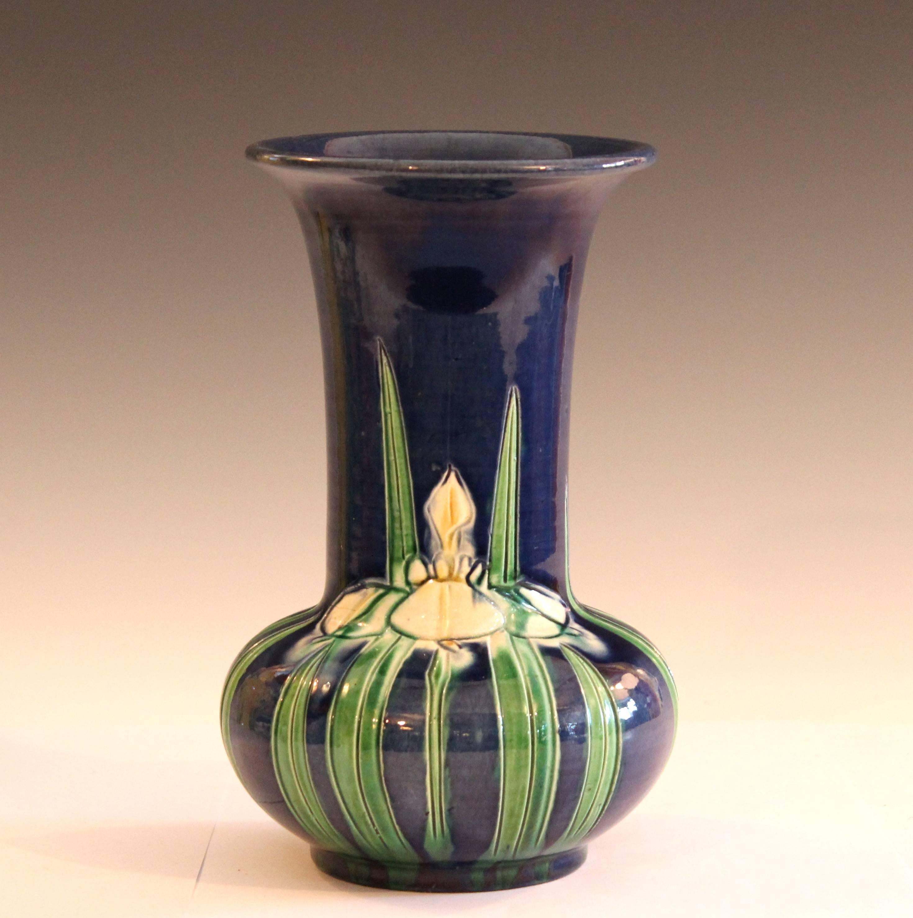 Awaji pottery trumpet form vase with incised iris design on unusual blue ground, circa 1920. Measure: 8 1/4