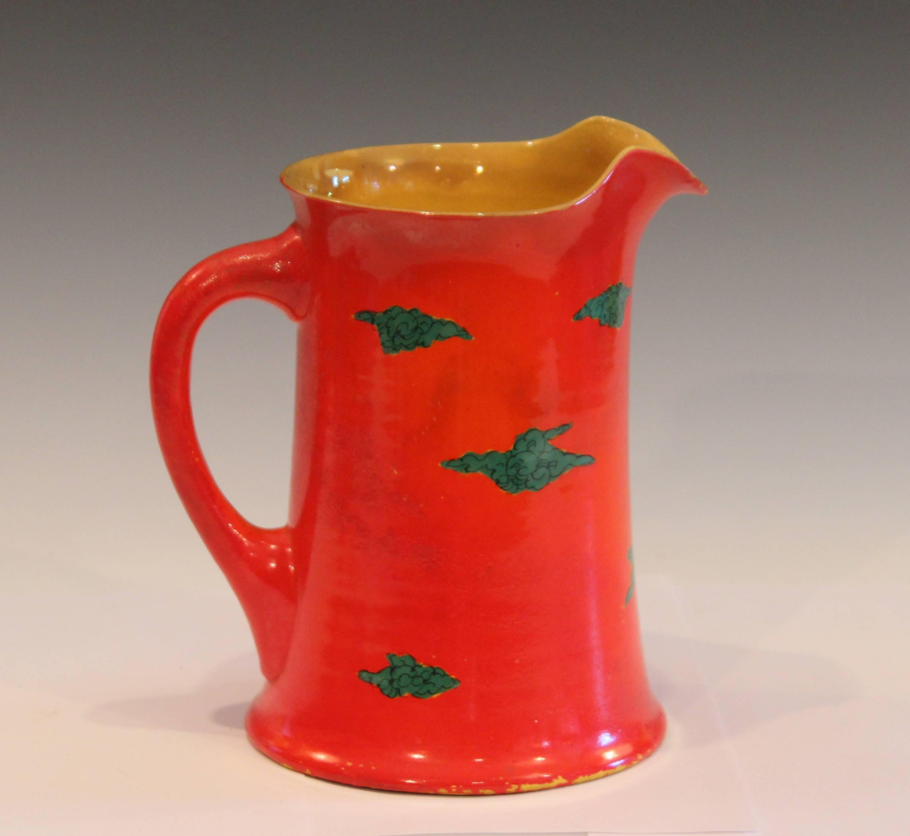 Unusual Awaji pottery pitcher with chrome red ground and dragon among the clouds theme, circa 1920. Measures: 8 1/4