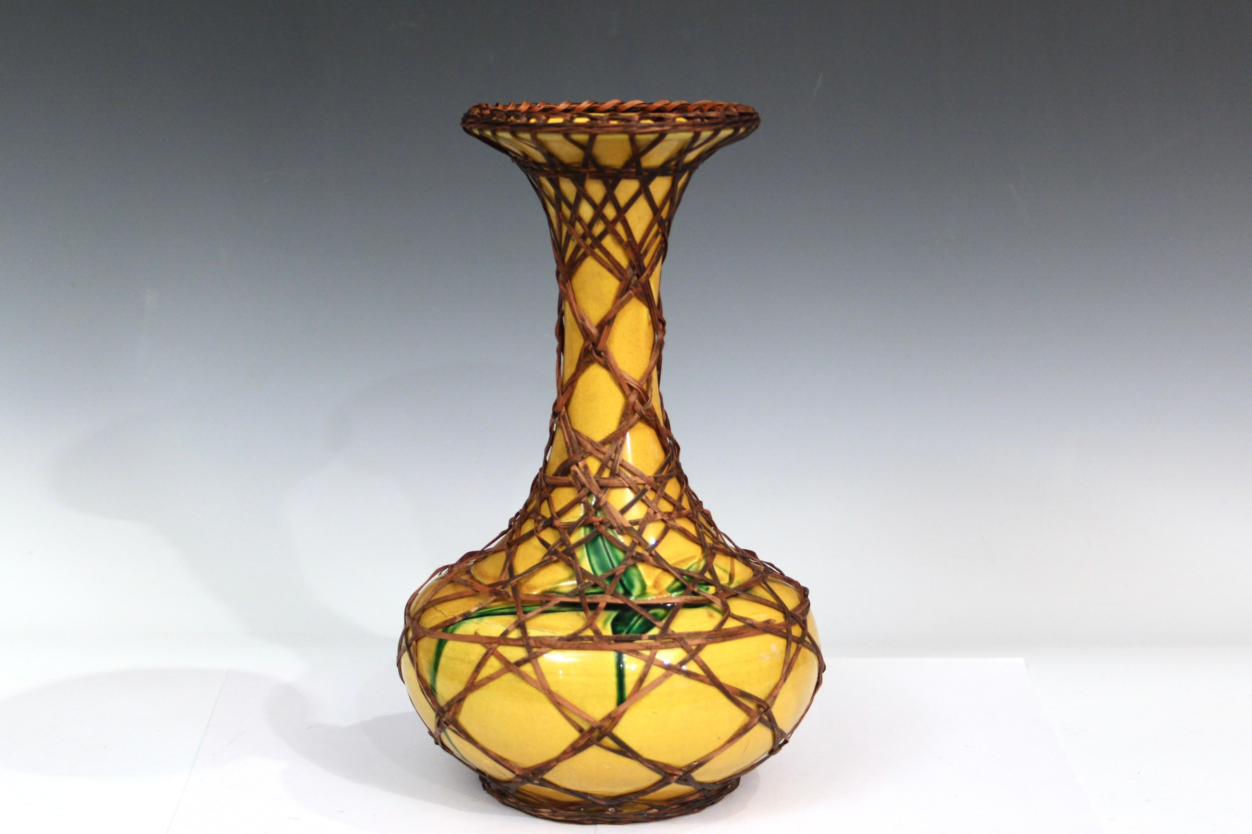Japanese Awaji pottery vase with split bamboo weaving. Bottle form vase with flaring mouth in bright, warm yellow glaze with incised bamboo motif glazed in green. 12
