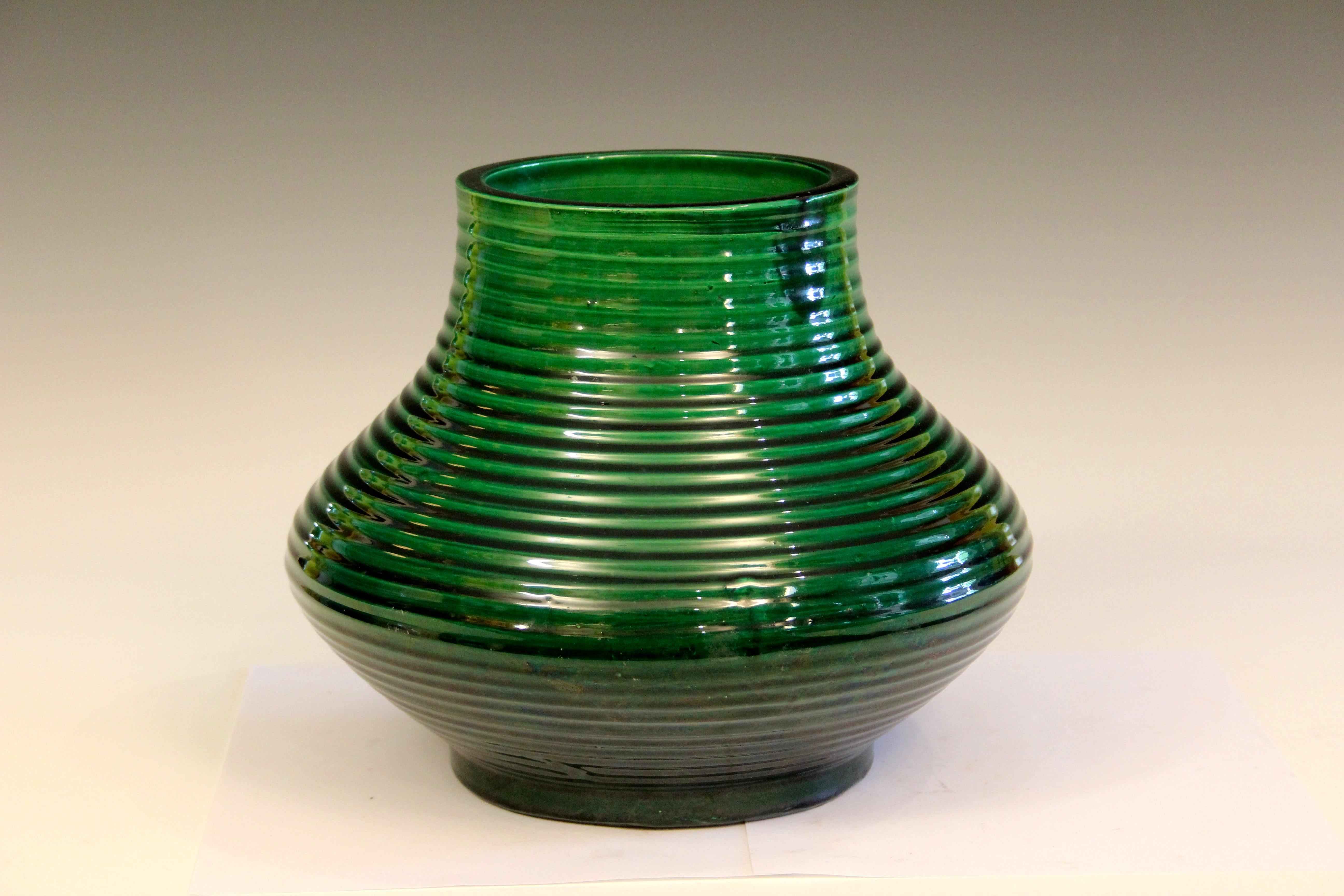 Antique Awaji pottery vase in Hu form with organic swirled grooves and great emerald green monochrome glaze, circa 1920. Measures: 9