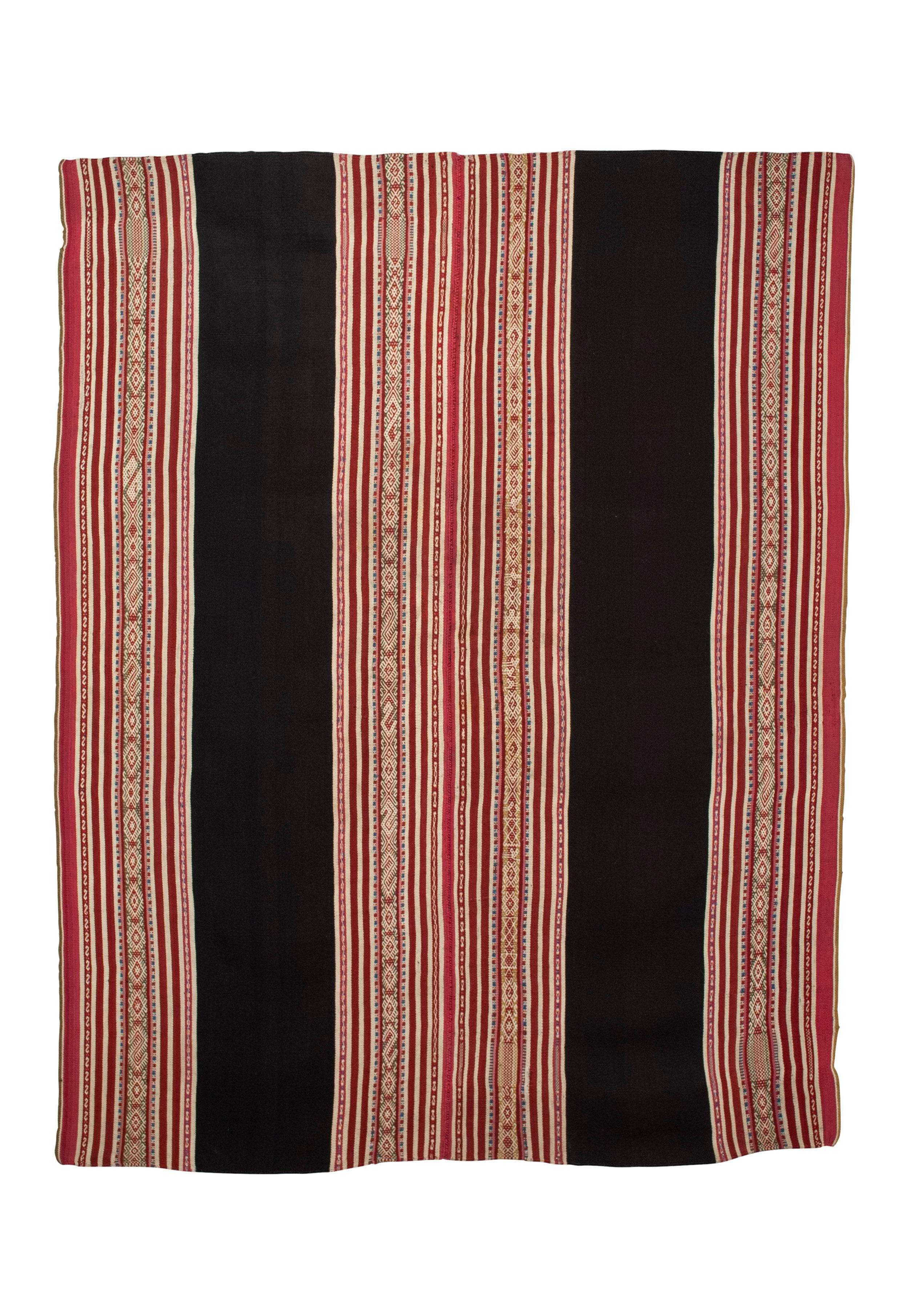 Antique Aymara Woman’s Mantle (Ahuayo), Bolivia

A large, finely woven and intricately patterned woman’s mantle from the Pacajes region of Bolivia displaying three wide vertical sections of narrow stripes and bands of detailed pattern weave