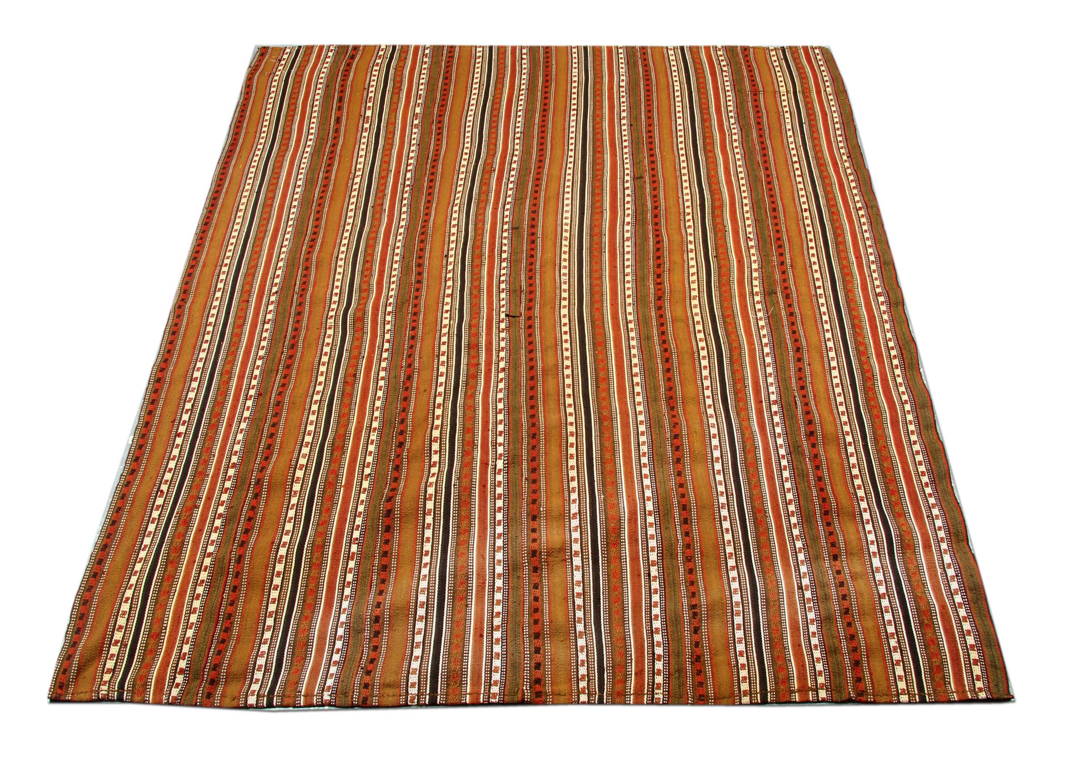 Rust-orange, brown, red and ivory make up the main colors in this elegant wool Jajim. Wove by hand with a stripe geometric design. Both the color and pattern make this piece easy to style in any home interior.
Constructed with fine, hand-spun wool