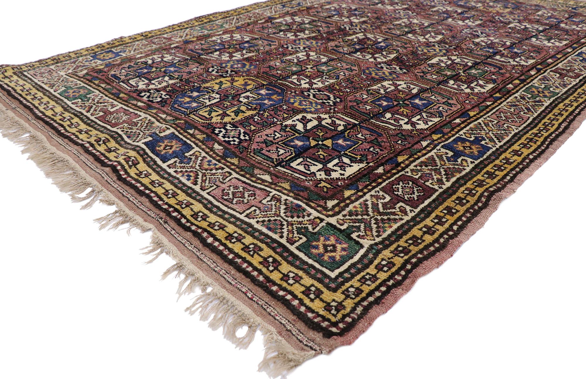 60892 antique Azerbaijan rug with Mid-Century Modern Tribal style 05'01 x 08'01. With its warm hues and rugged beauty, this hand-knotted wool antique Azerbaijan rug beautifully embodies a Mid-Century Modern tribal style. The abrashed purple hued