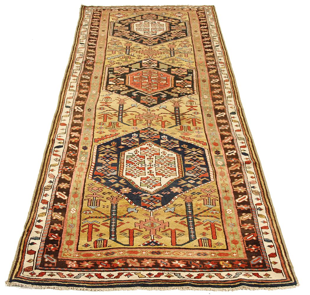 Antique Azerbaijan rug handwoven from the finest sheep’s wool and colored with all-natural vegetable dyes that are safe for humans and pets. It’s a traditional Azerbaijani design featuring three mixed floral and geometric medallions on its center