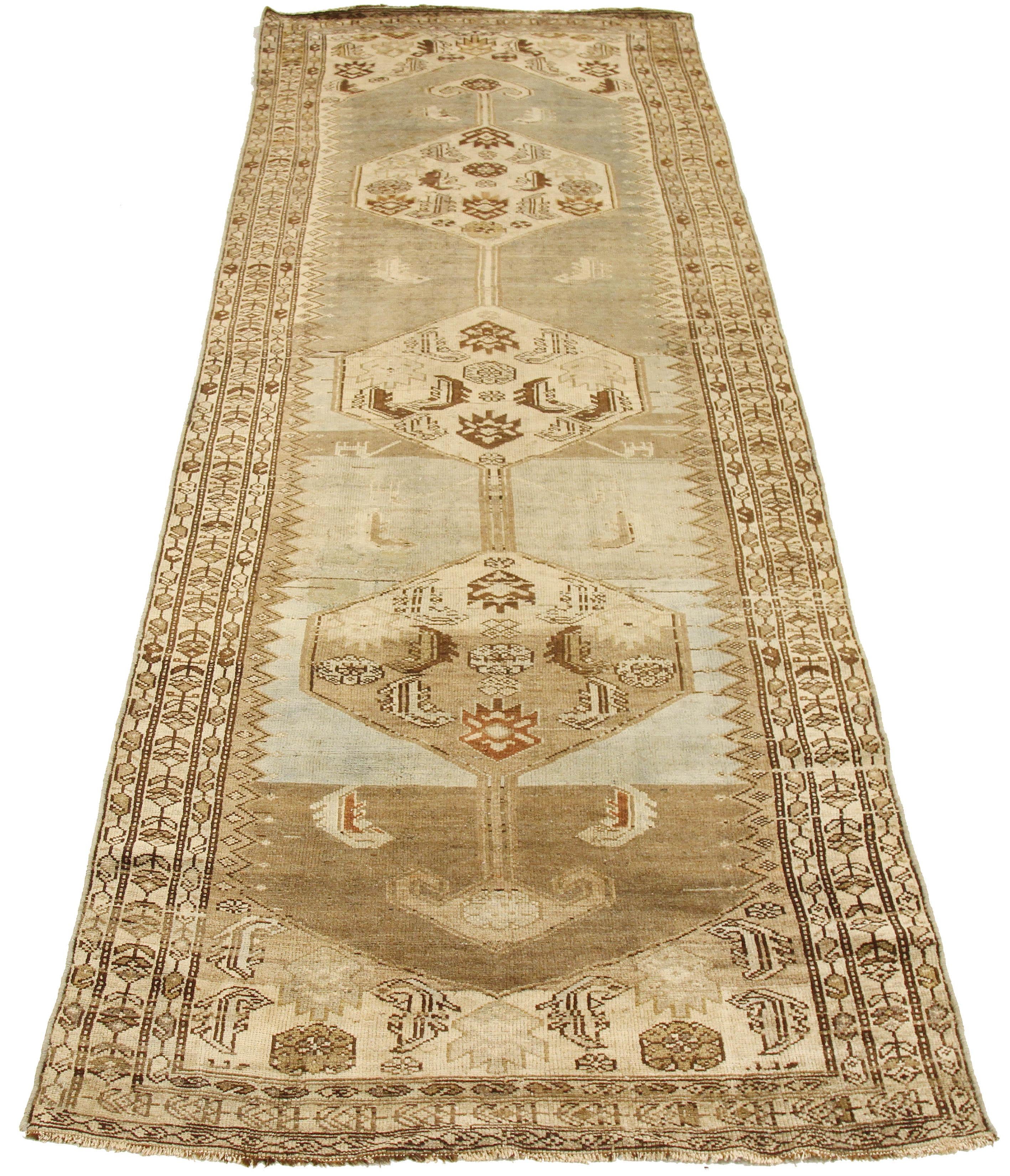 Antique Azerbaijan runner rug handwoven from the finest sheep’s wool and colored with all-natural vegetable dyes that are safe for humans and pets. It’s a traditional Azerbaijani design featuring mixed floral and geometric details over an ivory