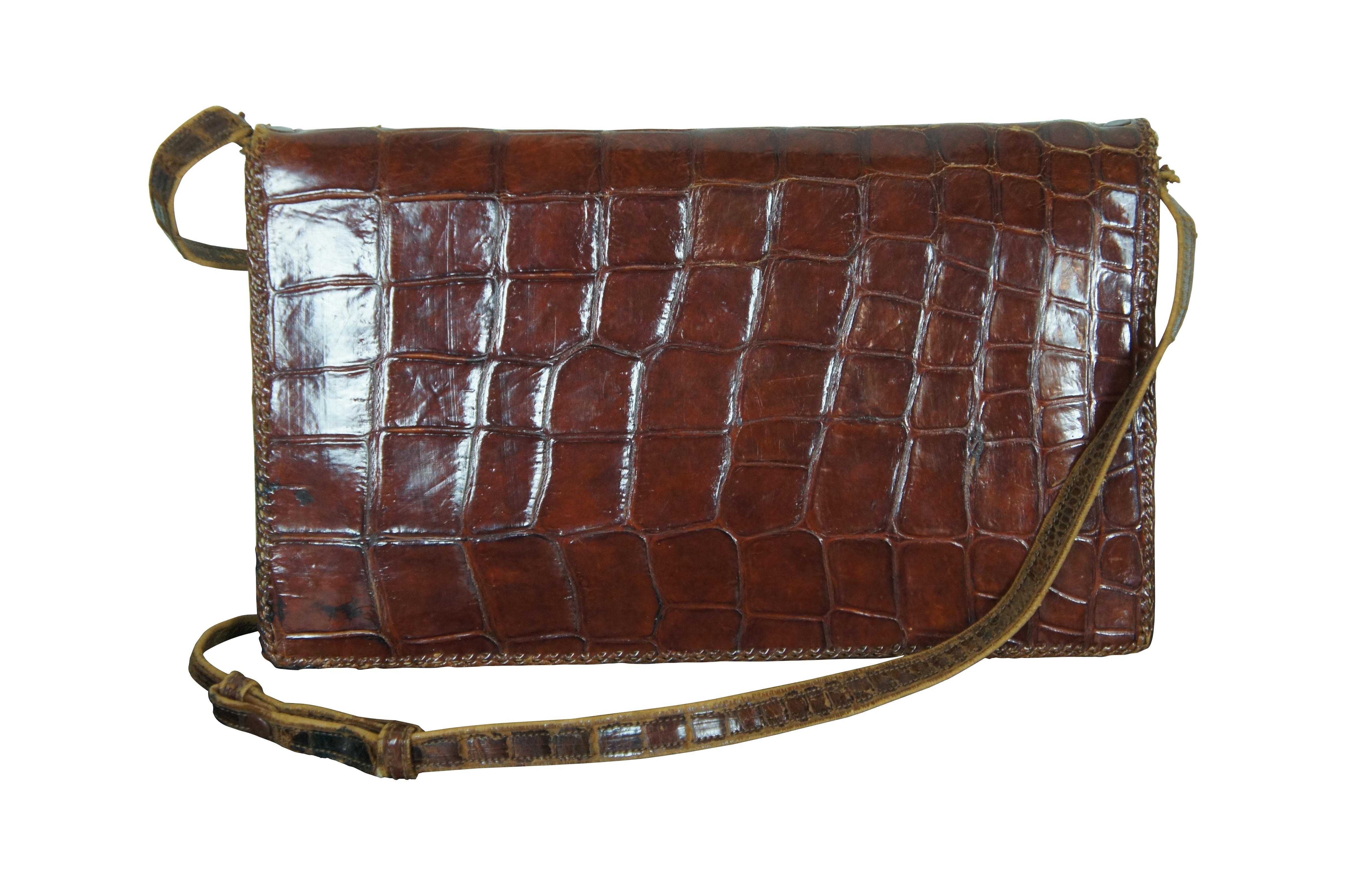 Antique / Mid Century / Circa 1940's brown alligator skin / leather hand bag / purse. Rectangular form with taxidermied baby alligator / crocodile on the front with red rhinestone eyes. Adjustable shoulder strap, snap closure,  three interior