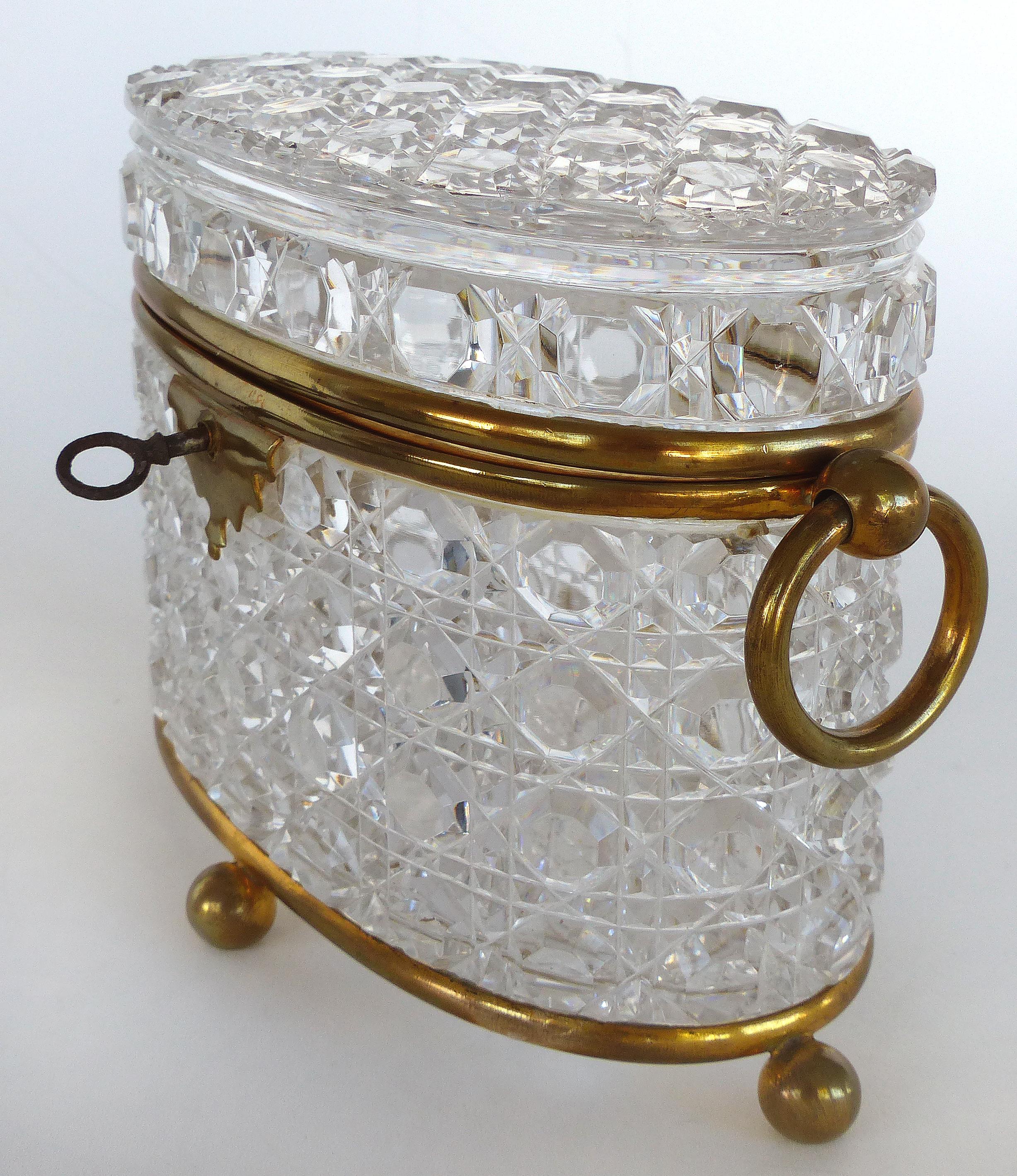 Antique Baccarat Cut Crystal Bronze Mounted Footed Oval Box with Original Key

Offered for sale is a wonderful antique cut crystal and bronze box attributed to Baccarat. The oval shaped box is mounted and supported by bronze ball feet and has a lock
