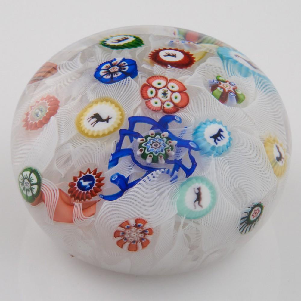 Heading : An Antique Baccarat Gridel B1848 Muslin Paperweight 1848
Date :1848
Origin : France
Features : A spaced millefiori weight on a muslin ground with ten gridels of two butteflies, cock, elephant, monkey, horse, stag, goat, duck and dog
Marks