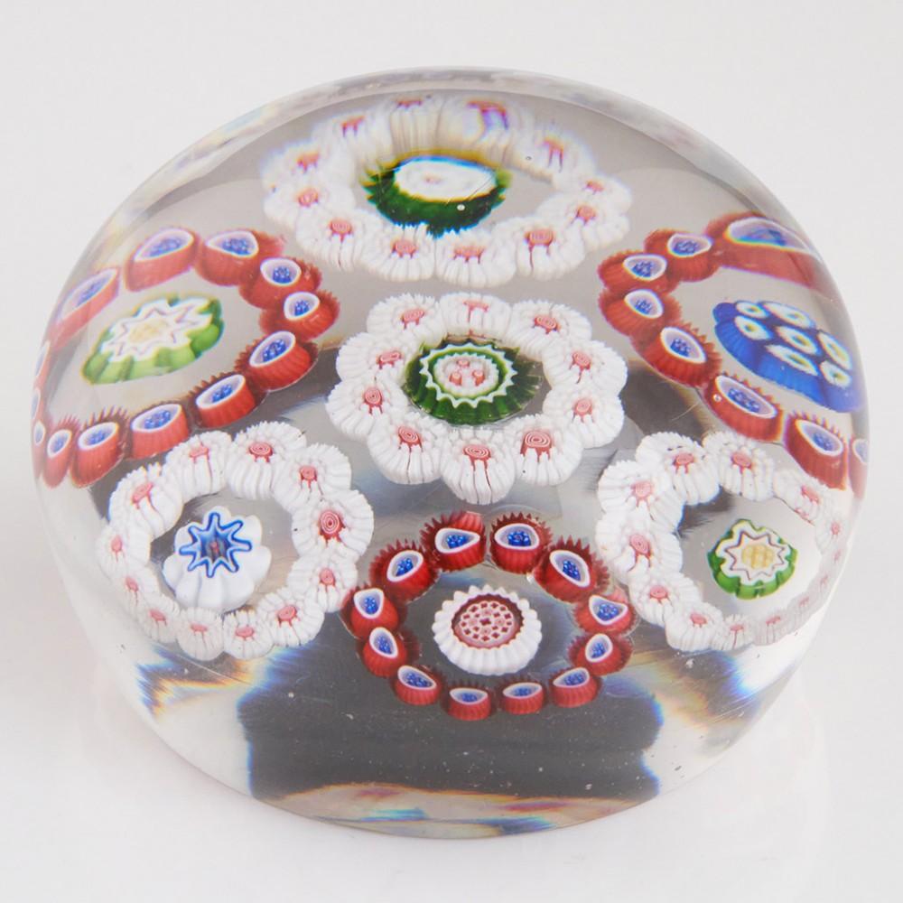 Heading : An Antique Baccarat Rondello Circlet Millefiori Paperweight c1850 
Date : c1850
Origin : France
Features : Central roundel of millefiori canes with six outer alternating roundels of red and white canes
Marks : none
Type : Lead
Size : 6.84