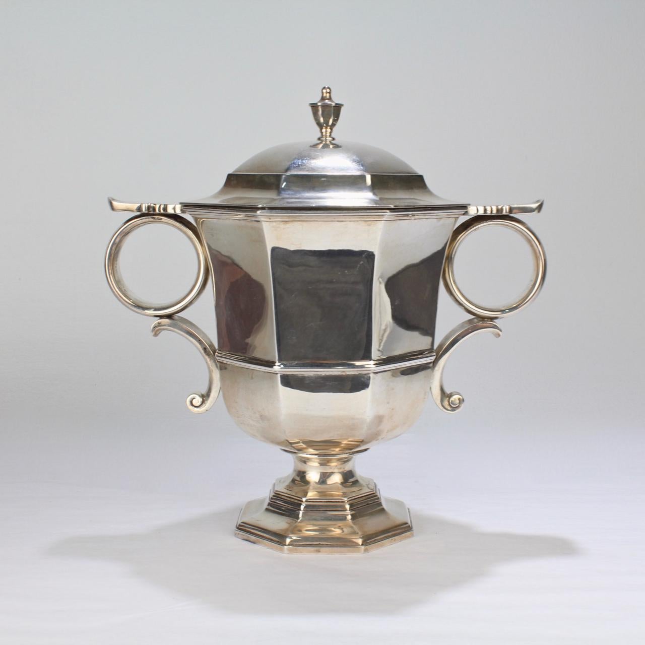 A wonderful sterling silver loving cup and cover by the celebrated Philadelphia jewelers and silversmiths - Bailey, Banks, and Biddle.

A faithful copy of a George II Loving Cup with a urn form body, loop handles, and a conforming cover, it is one