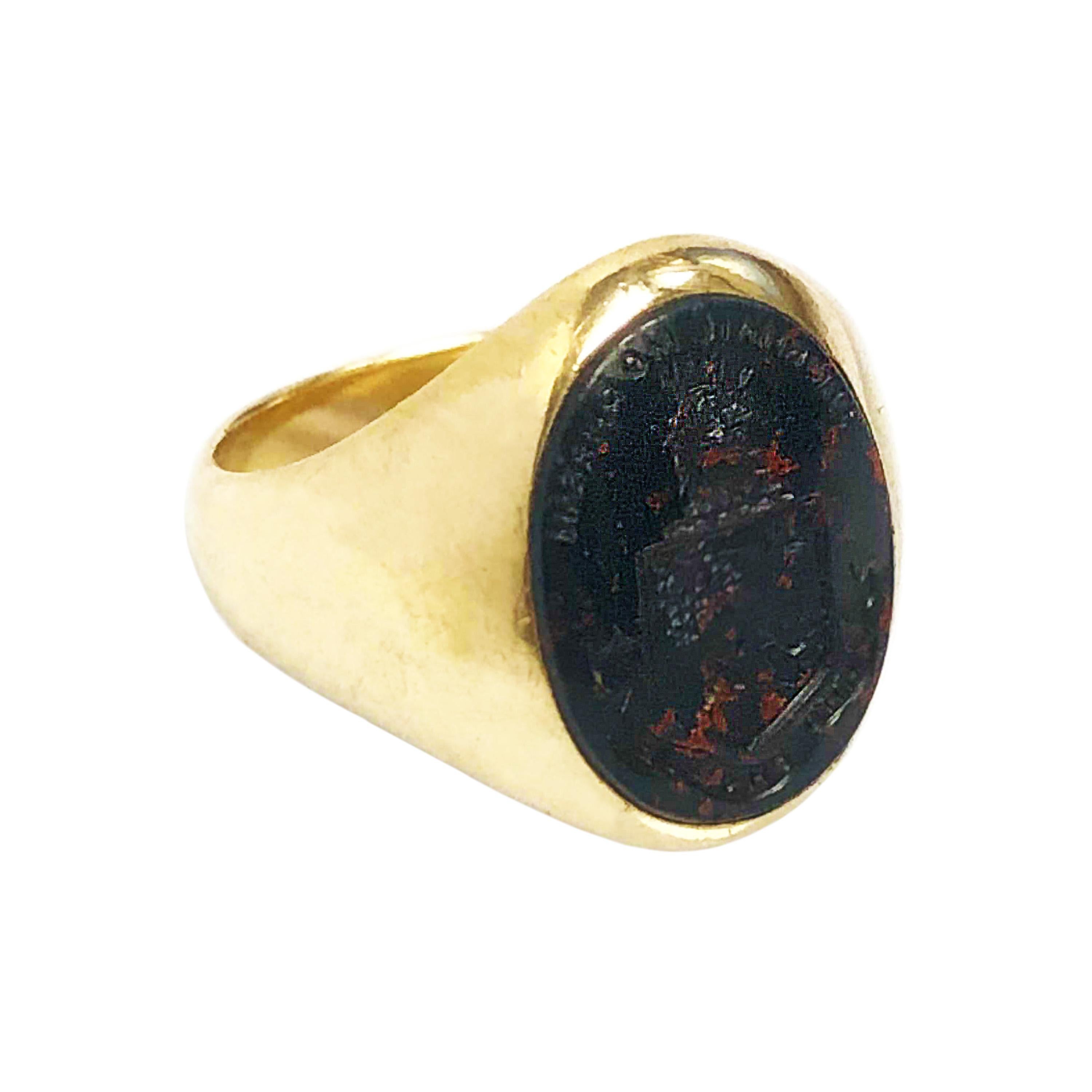 Circa 1910 Gents 18K Yellow Gold Signet Ring by Bailey Banks & Biddle. Centrally set with a carved oval Blood Stone featuring a Family Crest. The stone measures 16 X 11 MM. Finger size 7 1/2 