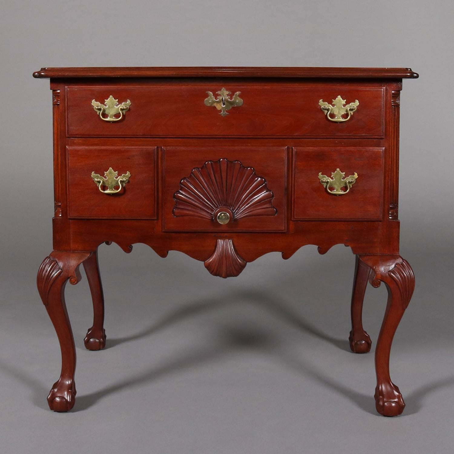 Antique Baker School Chippendale lowboy features locking upper long drawer with key above smaller drawers with central caved shell over scalloped skirt and seated on cabriole legs with acanthus knees and claw and ball feet, bronze pulls, 19th