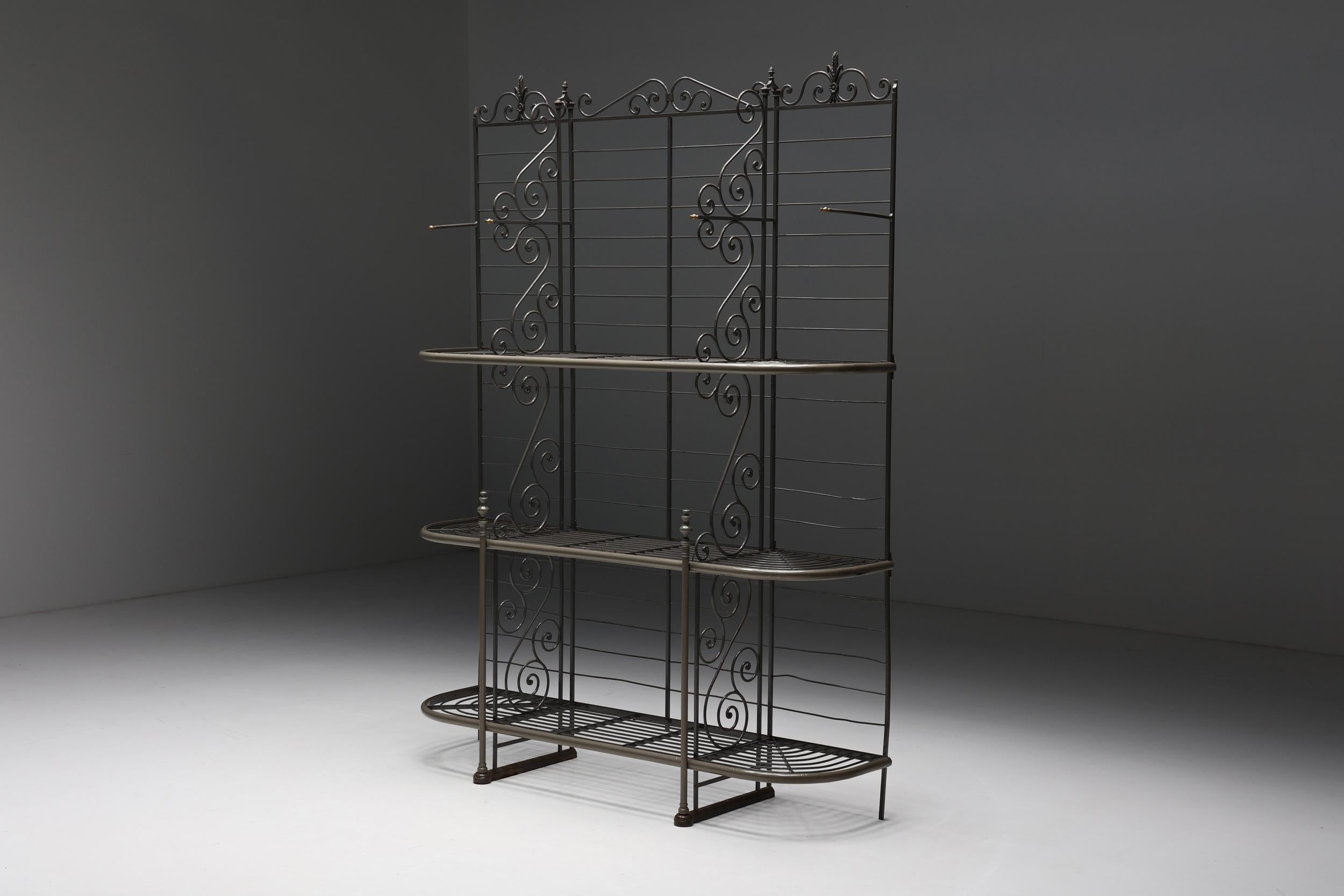 Antique bakery rack; wrought iron; 1920s; shelves; storing; storage unit; bakers shelving; 

Antique bakery rack in wrought iron, dating back to the 1920s. Sculptural storage unit, characterized by its curly detailing. This piece consists of three
