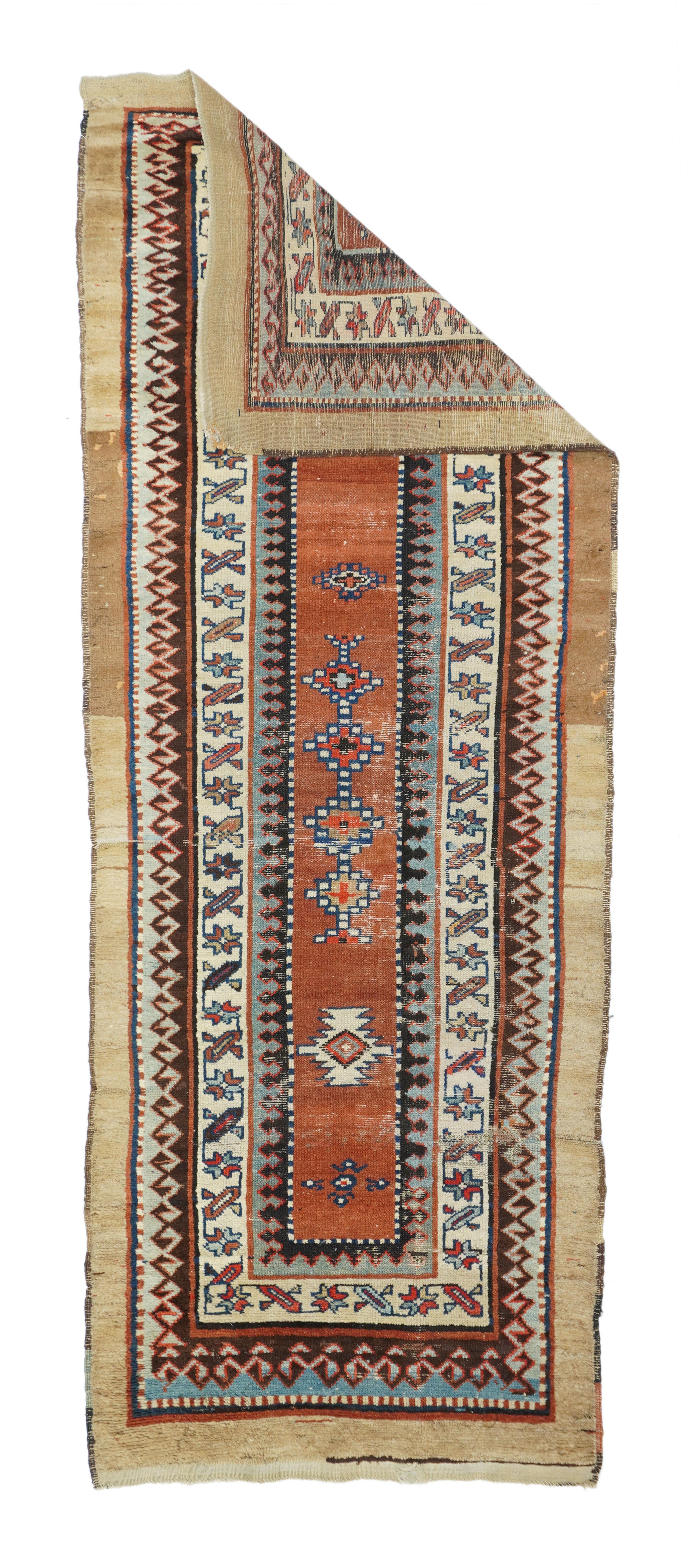 In the Caucasian Talish mode with a narrow madder field displaying a short pole medallion and two ivory ashiks. Abrashed plain camel-tone outer border. Main border of stars and diagonal bars. Wool foundation. Moderate weave. Good condition with full