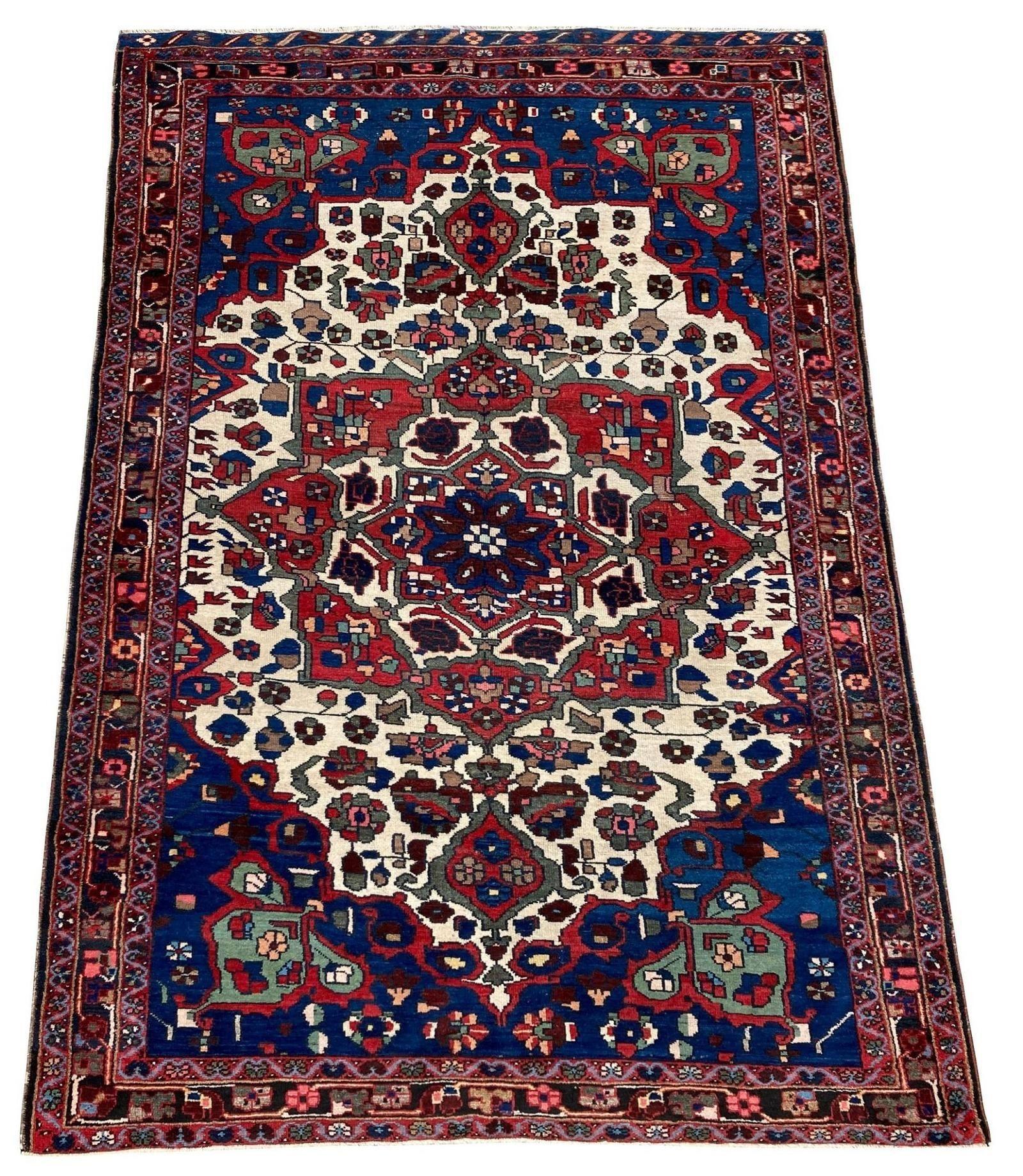 A beautiful antique Bakhtiar rug, handwoven circa 1910 with a circular medallion on an ivory field of stylised flowers. Lovely wool quality and fabulous secondary colours!
Size: 1.92m x 1.35m (6ft 4in x 4ft 5in)
This rug is in good, original