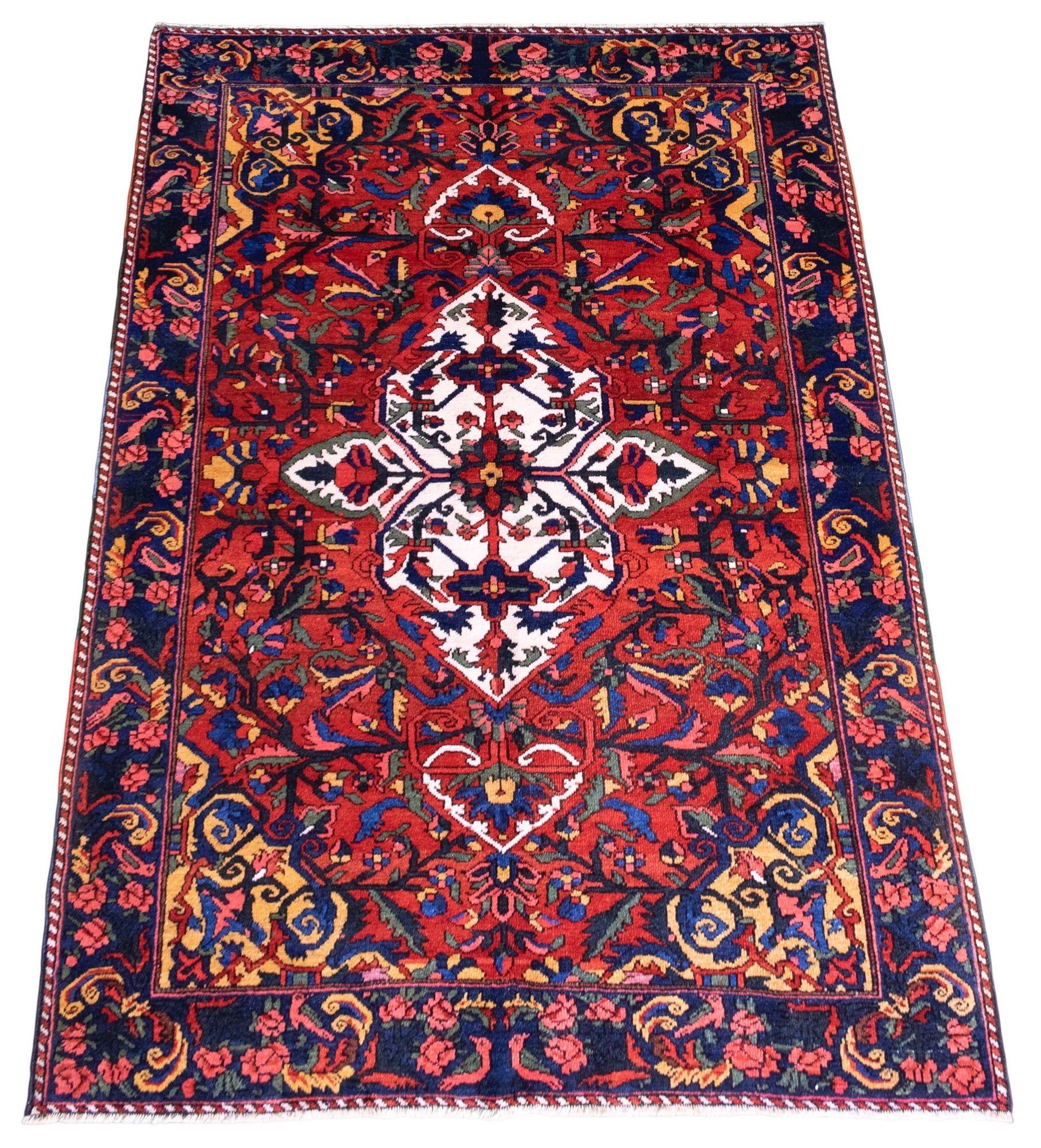 A beautiful antique Bakhtiar rug, hand woven circa 1920 with a single medallion floral design on a terracotta field and indigo border. Wonderful secondary colours of greens, pinks and golds and a highly decorative antique rug.
Size: 2.05m x 1.46m