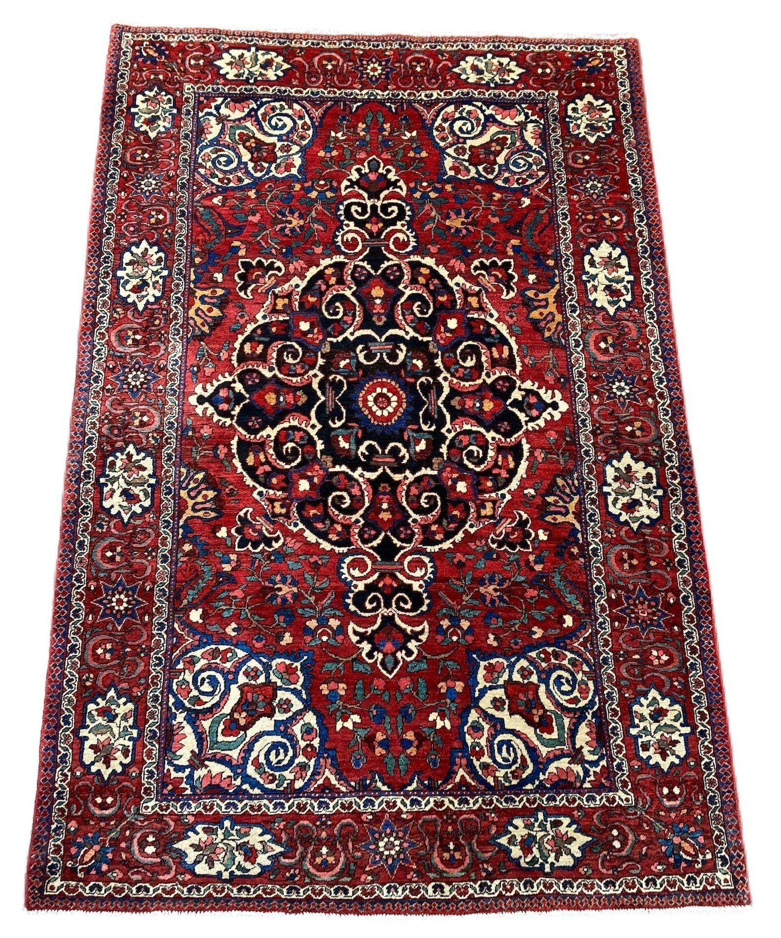 A beautiful antique Bakhtiar rug, hand woven circa 1920 with a single medallion floral design on a terracotta red field and cartouche border. Wonderful secondary colours of blues, pinks and gold and a highly decorative antique rug.
Size: 2.11m x
