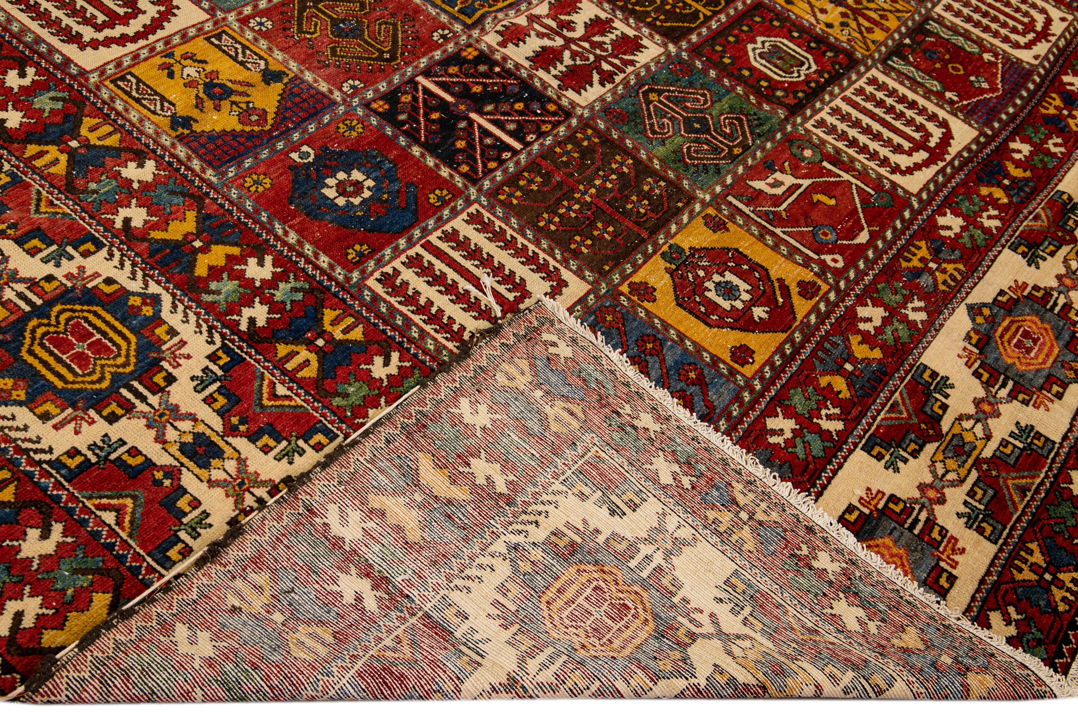 Beautiful antique Bakhtiari hand-knotted wool rug with a multicolor field. This piece rug has a beige frame and multi-color accents on a gorgeous Classic Multi floral pattern design

This rug measures 13'10