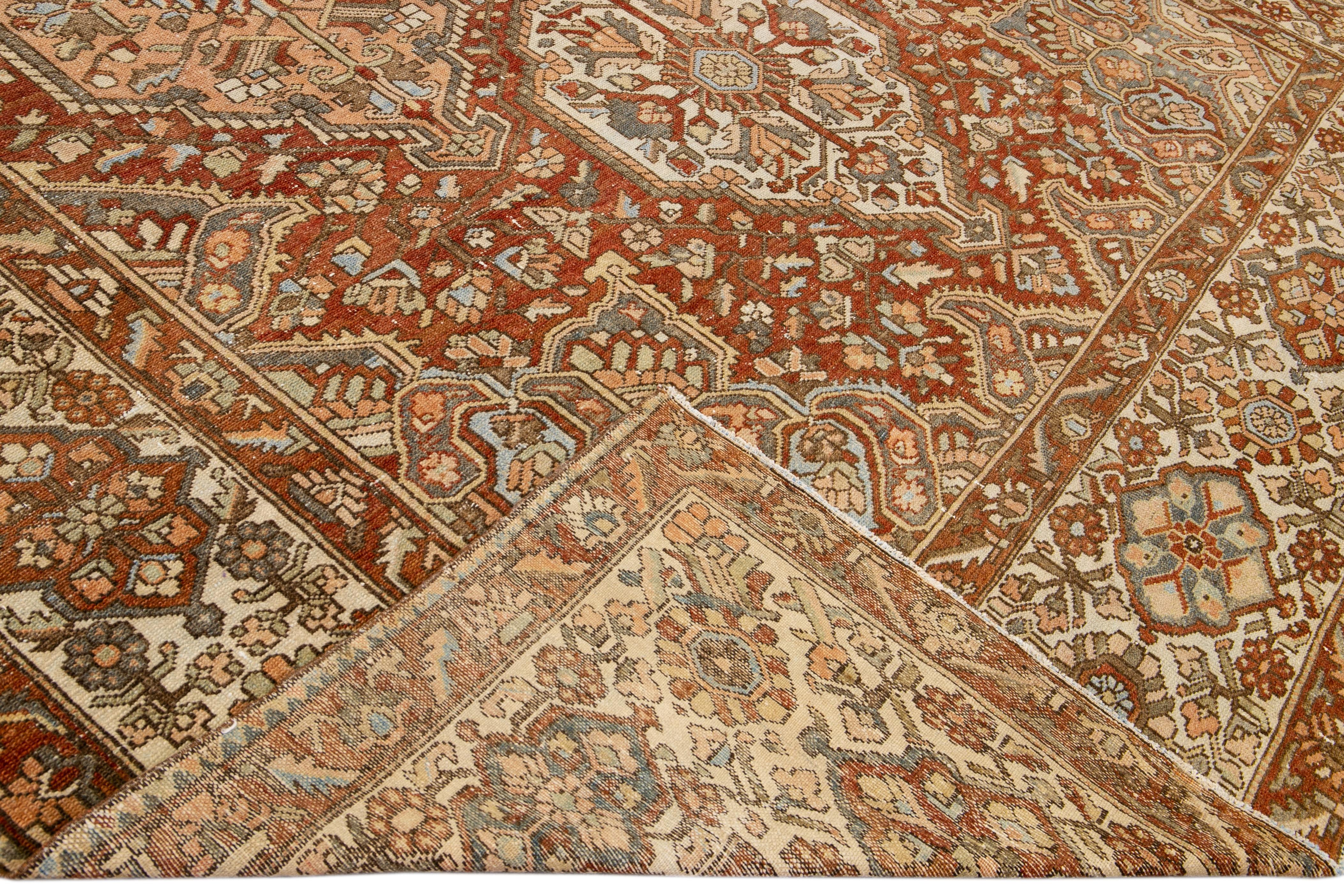 Beautiful antique Bakhtiari hand-knotted wool rug with a rust field. This piece rug has a beige frame, blue, peach, and brown accents on a gorgeous Classic Multi Medallion floral design

This rug measures 11'8