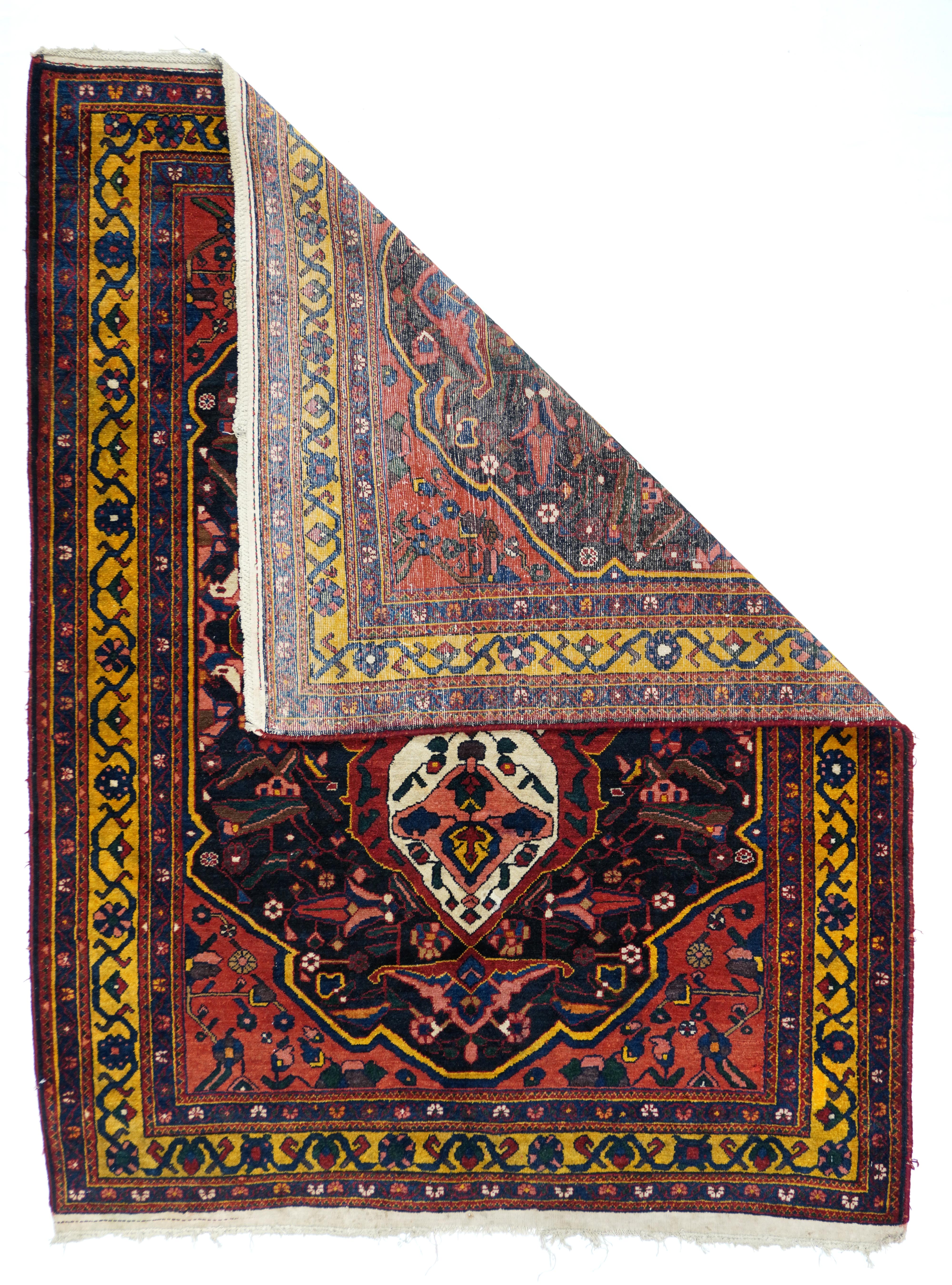 The influence of Heriz rugs was particularly strong in Chahar Mahal Bakhtiari weaving in much of the 20th century. This colourful antique scatter shows a bold ivory quatrefoil medallion enclosing four simple palmetttes, set on a slightly shaped