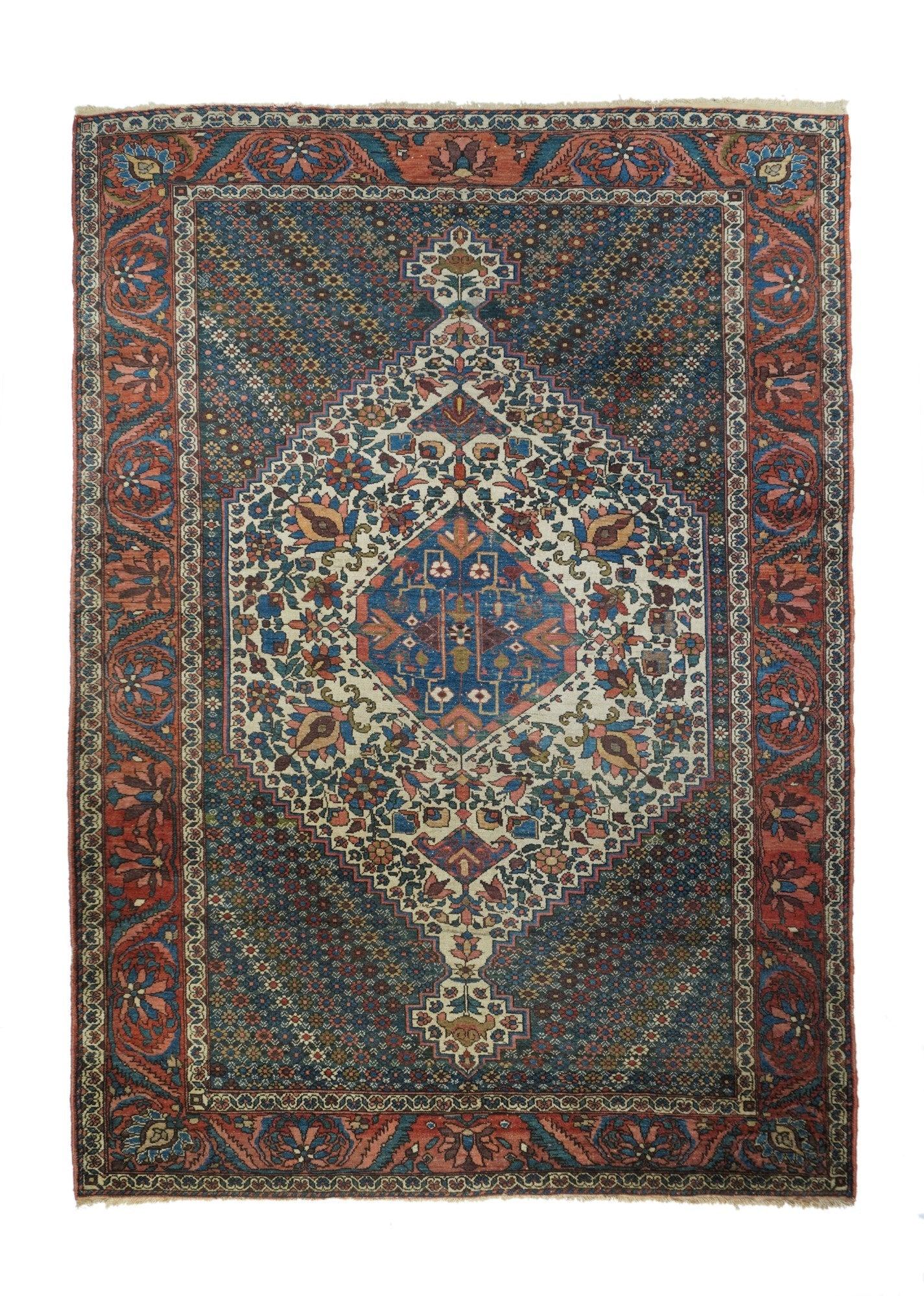 Antique Bakhtiari Rug 6'8'' x 10'3''. This well-woven rustic Chahar Mahal rustic scatter shows a star-rosette filled ground making color diagonals, and supporting an ecru stepped hexagonal with stepped pendants. Palettes are symmetrically placed