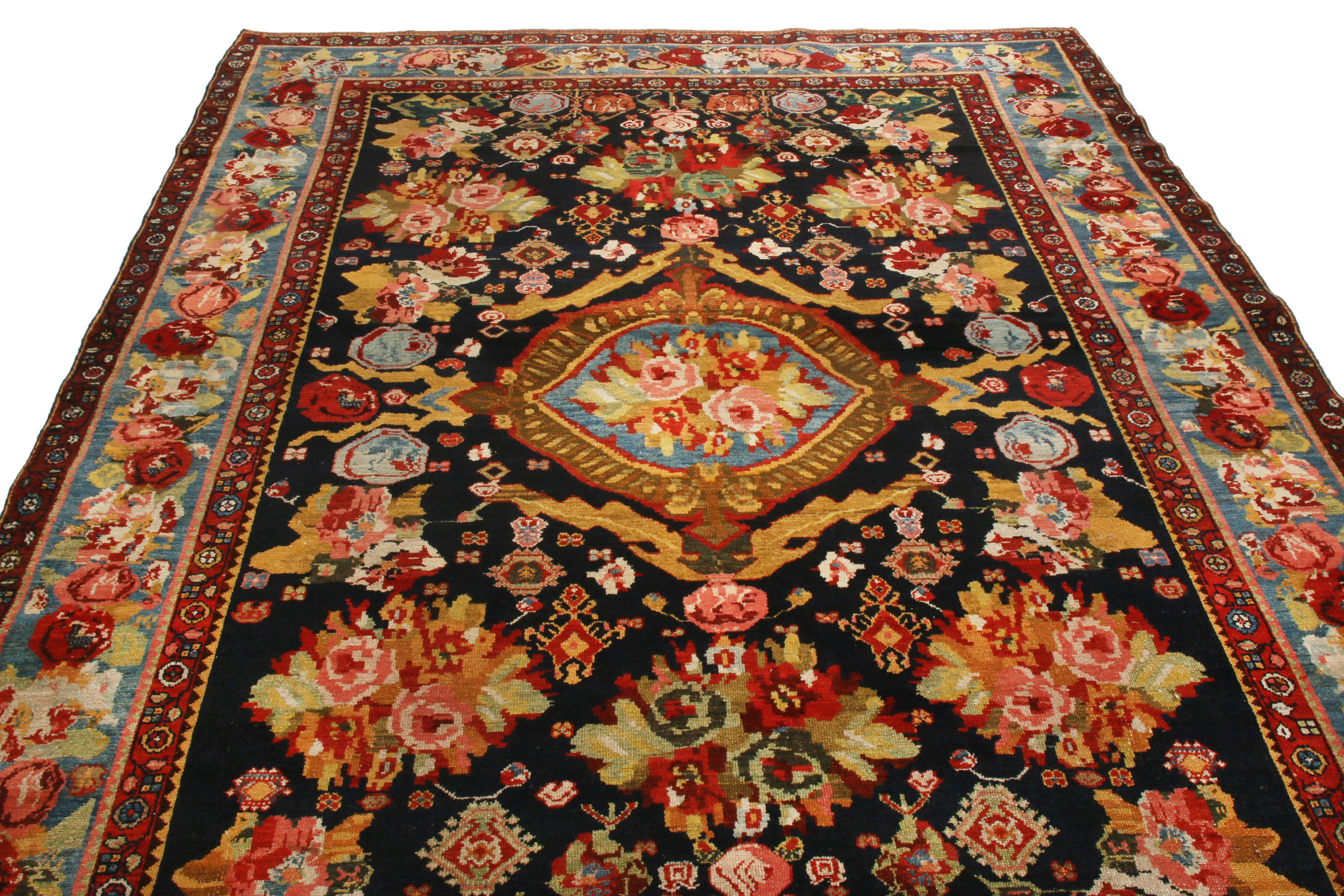 Originating from Persia between 1890-1900, this antique traditional Bakhtiari Persian rug features an exceptionally individualistic repetition of distinct floral imagery in rich and varied colourways. Hand knotted in high quality wool, the mirrored