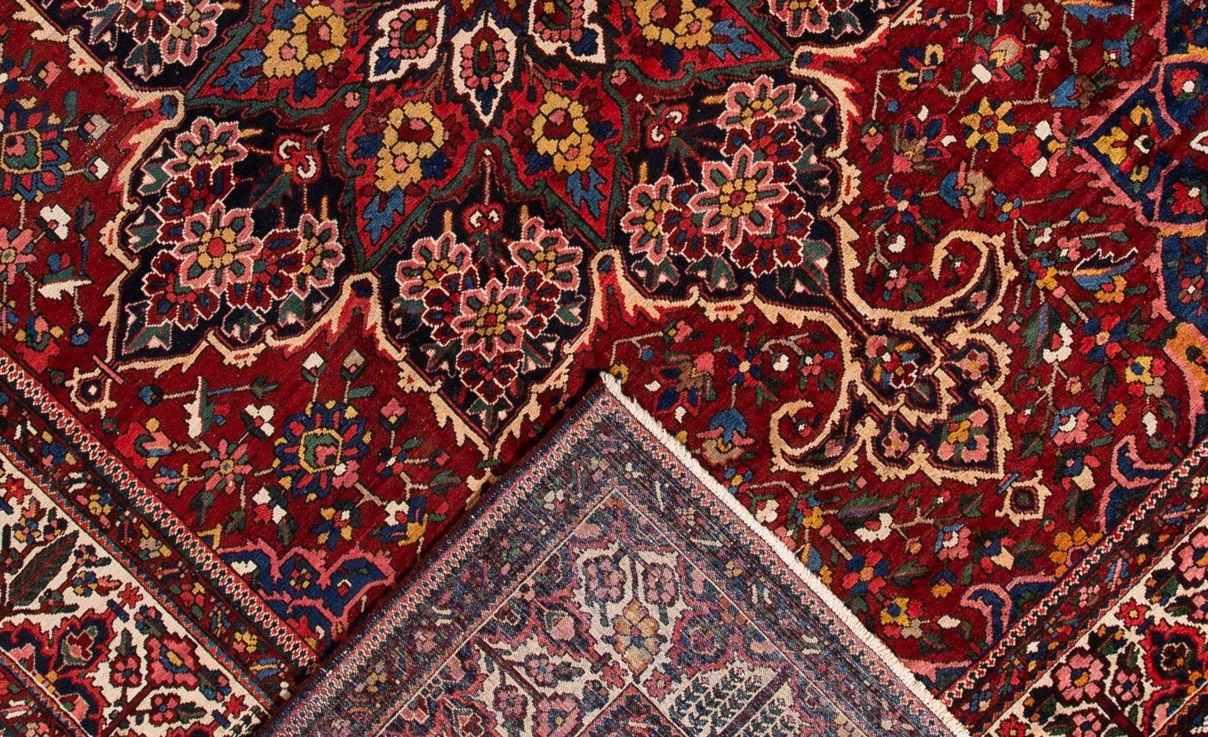 Beautiful Antique Bakhtiari Persian hand-knotted Wool rug with a red field. This Bakhtiari has multi-color accents in a gorgeous all-over medallion floral design.

This rug measures 11'5