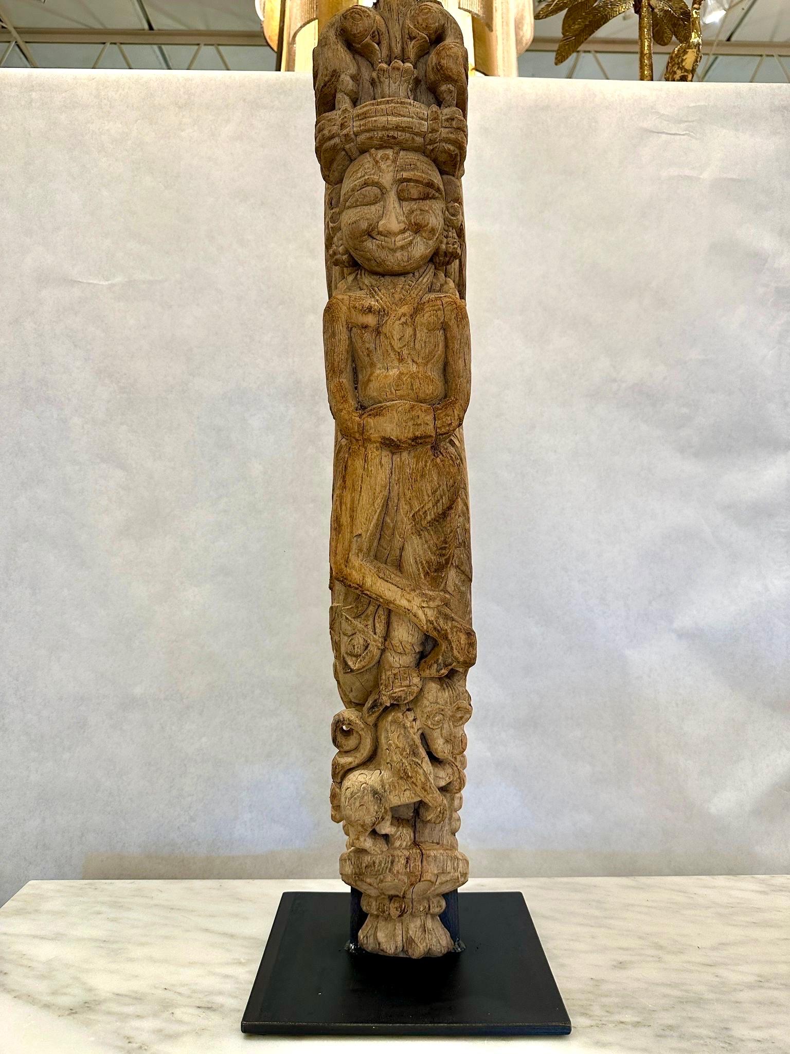 This roof mounted decorative element of a carved Buddha, was salvaged from a 19th C. Balinese building and we had it professionally mounted on an iron display base so as to highlight its amazing carvings and details.  NOTE: THIS ITEM IS LOCATED AND