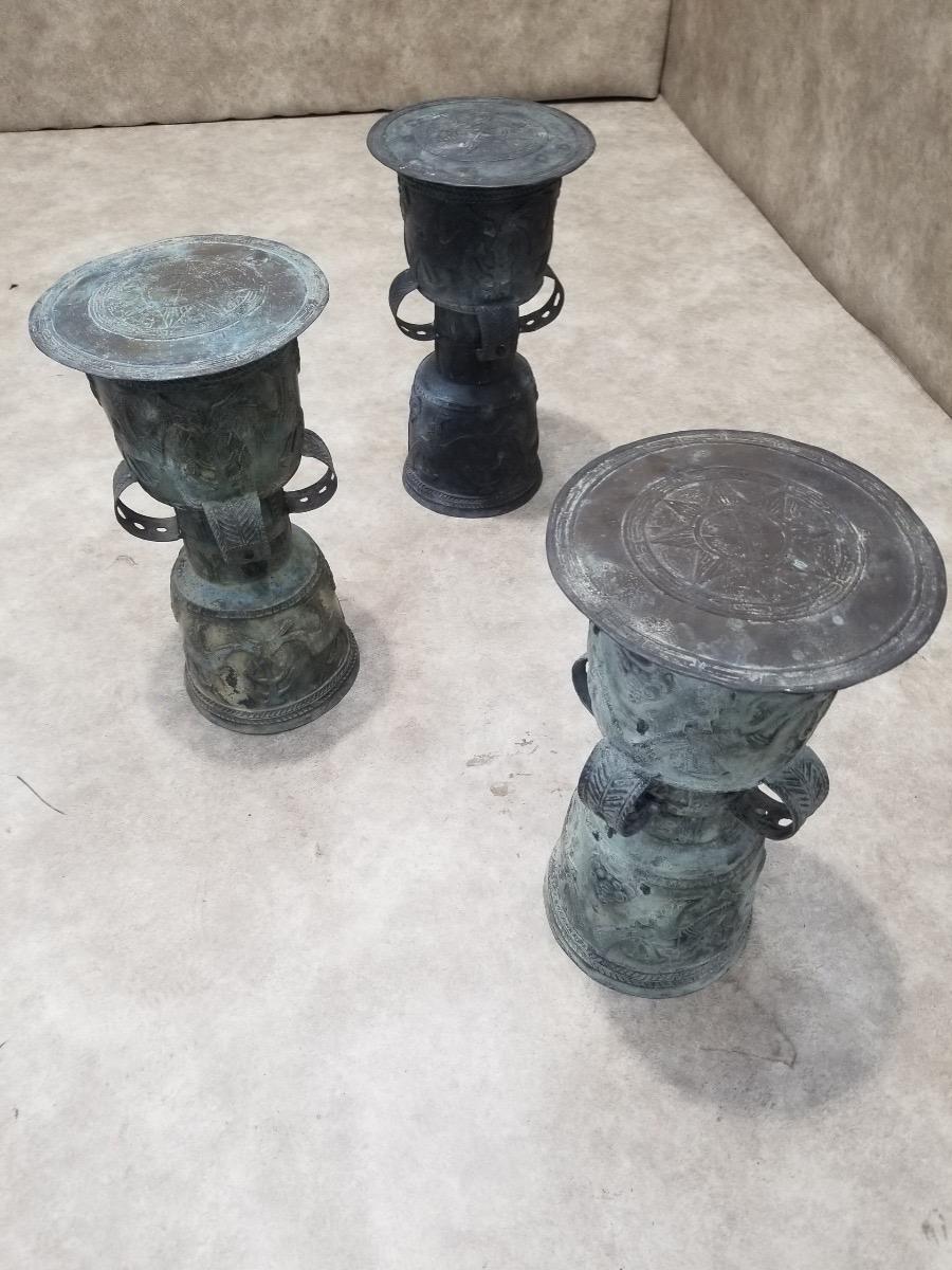 Antique Balinese Hammered Bronze Rain Drum Garden Stool/Plant Stand with Patina - Set of 3

Showcase Balinese craftsmanship at its finest with these rain drum sculptures with patina. This set features intricately detailed rain drum sculptures,