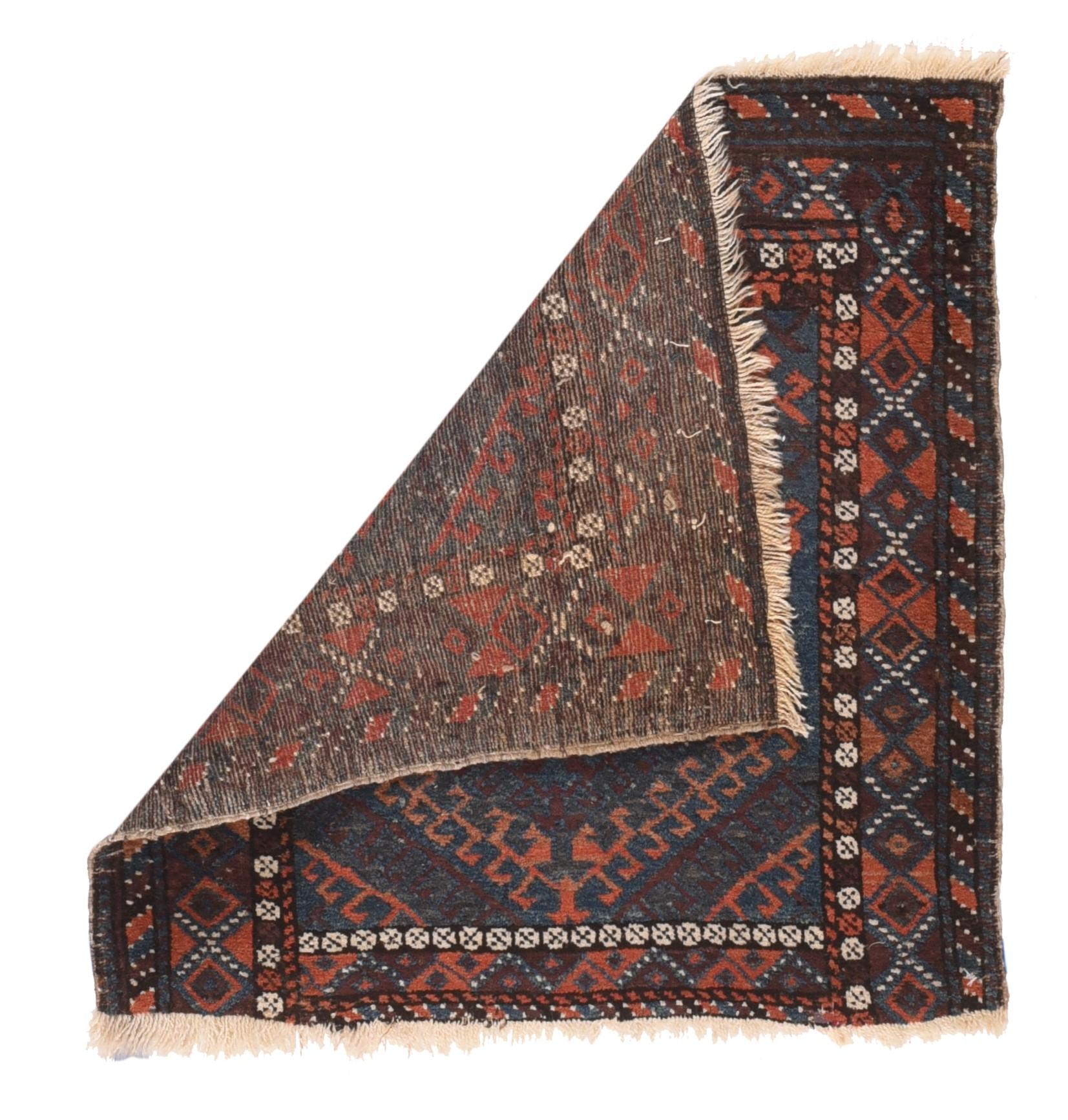 Antique Balouch Back Face Rug 2'1'' x 2'2''. This well-woven, nomadic artefact shows a border of hexagons and smaller diamonds, with a rosette inner stripe, all surrounding the layered field with rust-red, blue and aubergine ashiks and hooked