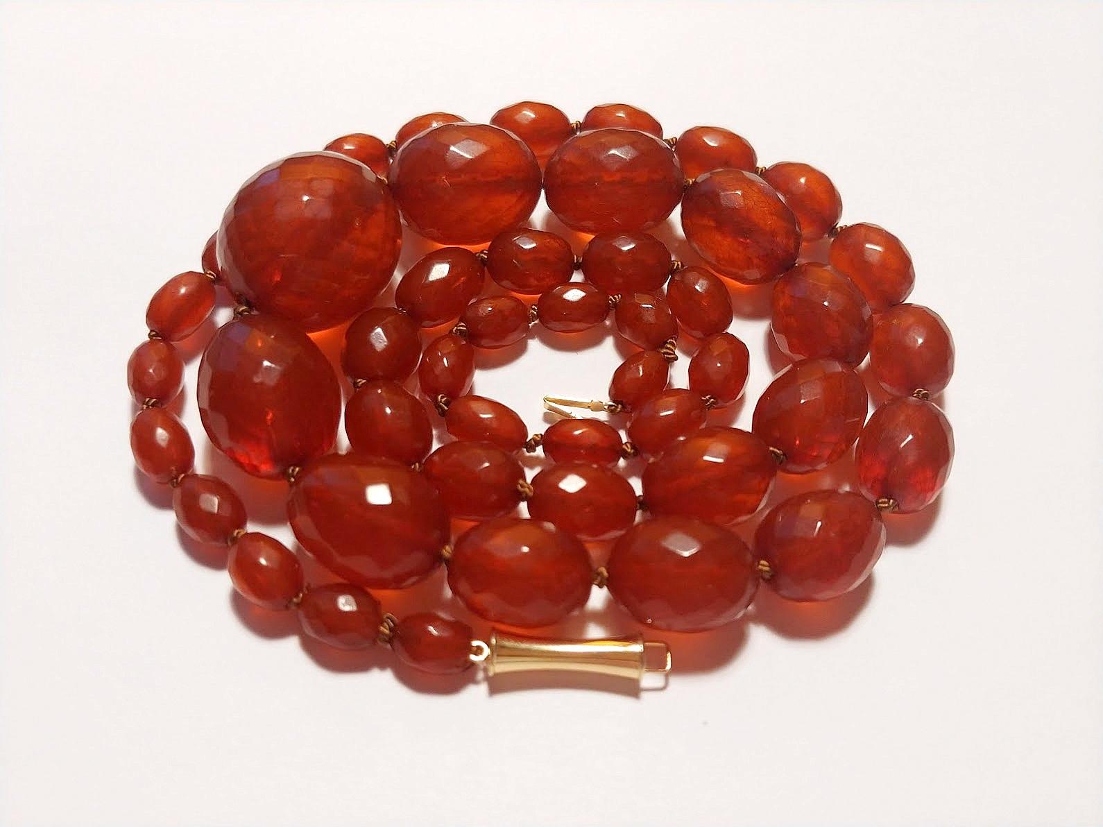 Genuine pre-war faceted Baltic amber

The length of the amber necklace is 28.5 inches (71 cm). The size of oval beads varies from 9 to 25.4 mm. The weight of the necklace is 48 grams. Long! Weightless!
The color of the beads is saturated cognac.
The