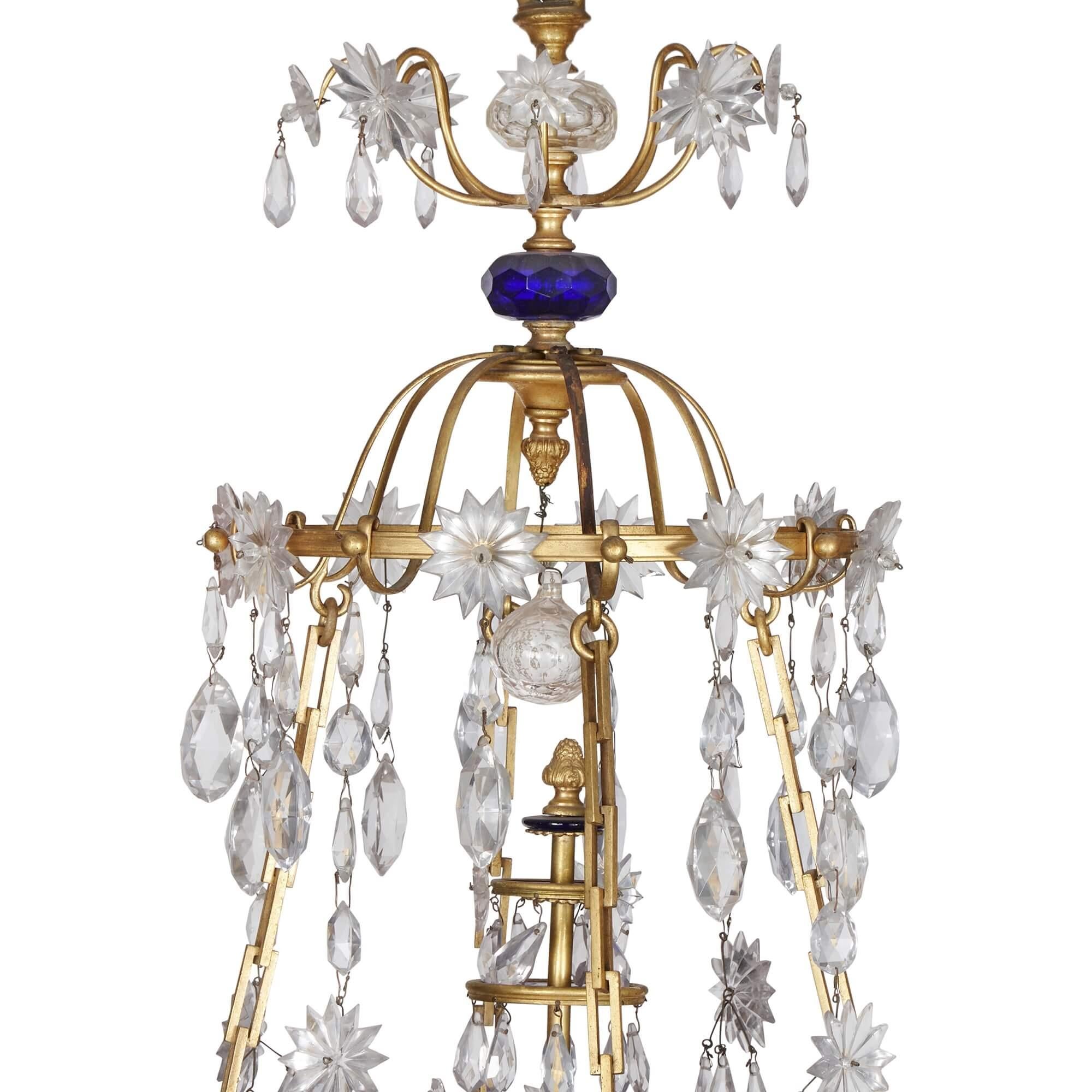 Baltic Neoclassical ormolu, blue and amethyst glass 16-light chandelier
Baltic, Early 19th Century 
Height 119.5cm, diameter 76cm

Wonderfully crafted in the early 19th century in the refined Neoclassical style, the chandelier showcases the expert