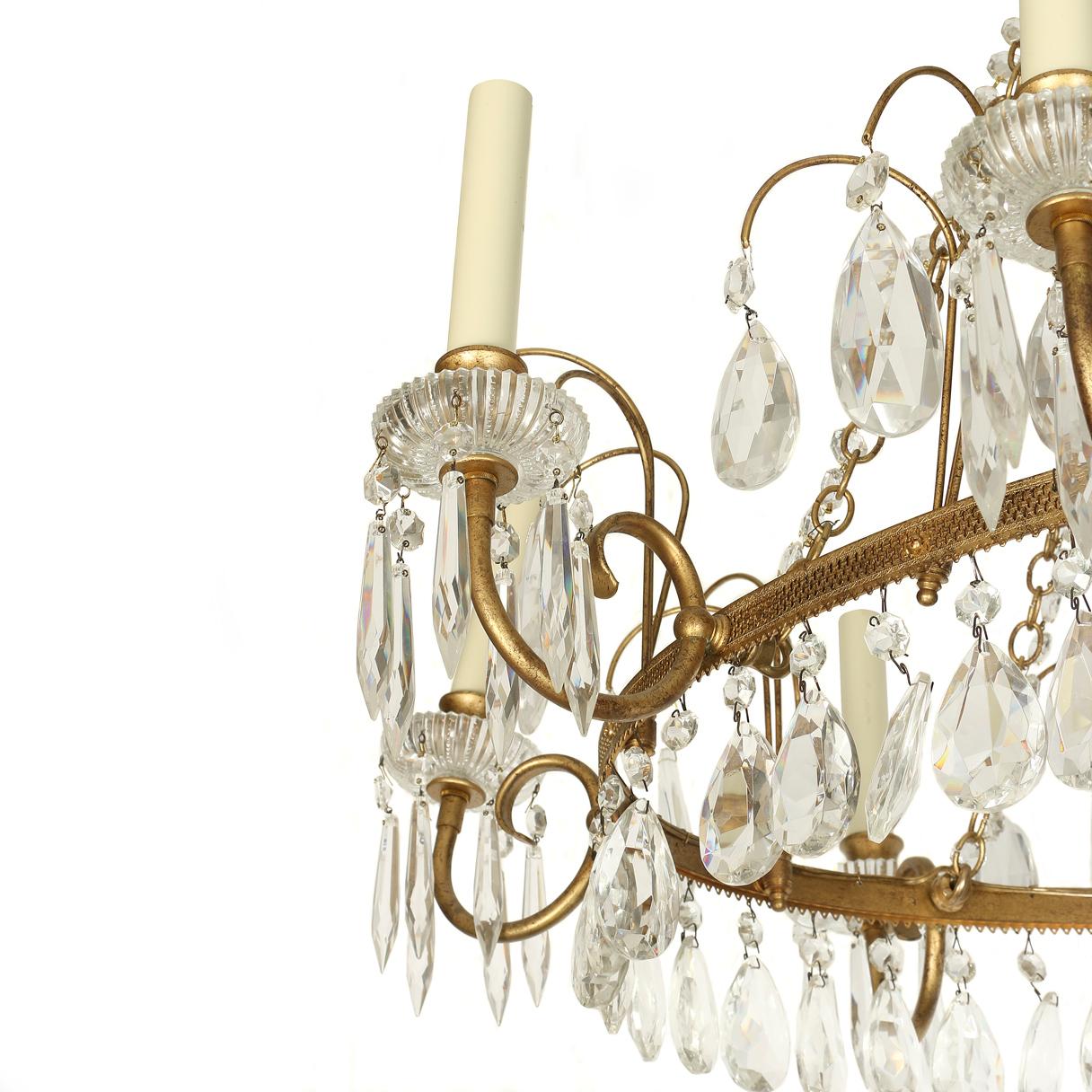 Antique Baltic gilt metal and crystal ten-arm chandelier in oval shape with three tiers.