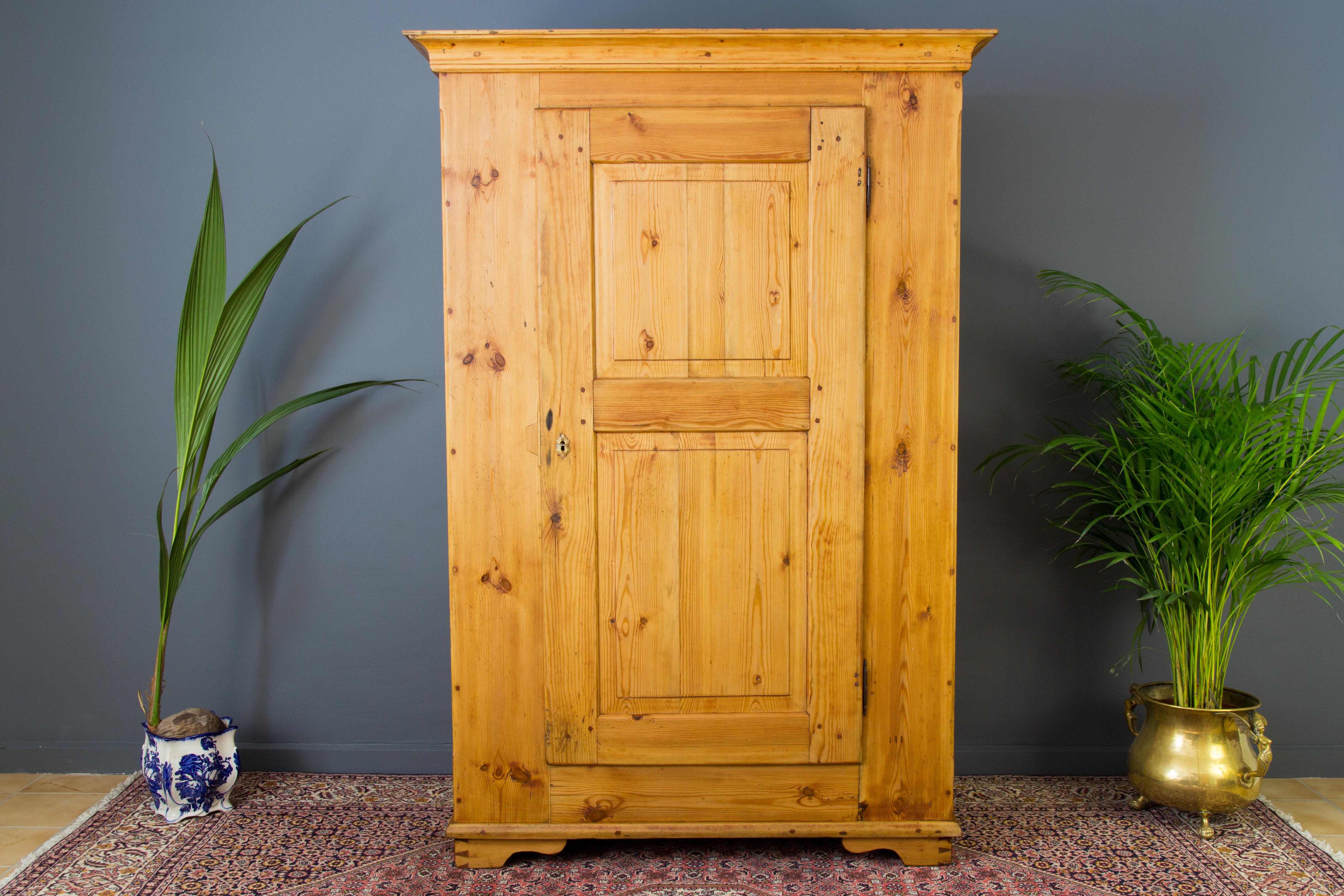 One-door armoire of Baltic pine with five shelves. The wardrobe is in one piece and is of very solid construction and in very good antique condition. Please expect some dents, marks and scuffs due to its age. This is a good very solid, rustic and