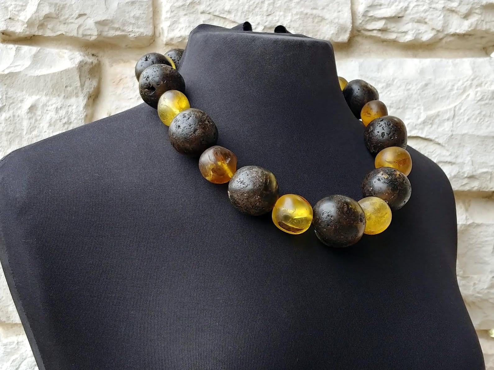 A genuine, ancient Baltic amber necklace weighing 229 grams, approx 1900s. The diameter of the largest bead approx 36mm. The diameter of the smallest bead approx 21mm. All beads were cut by hand, so they are not ideal round. They are not ideal, but