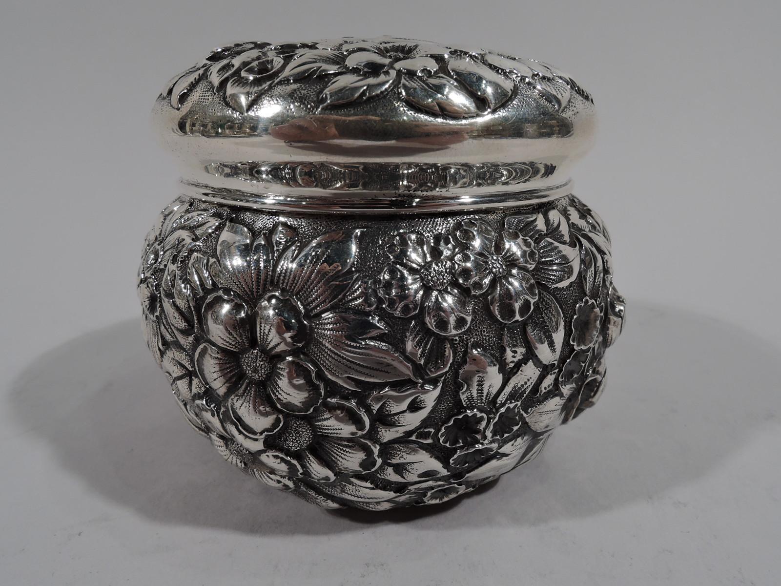 Turn-of-the-century Baltimore-style repousse sterling silver trinket box. Globular with curved and overhanging cover. Dense all-over flowers on stippled ground on sides and cover top. Cover top has central scrolled cartouche (vacant). Gilt-washed