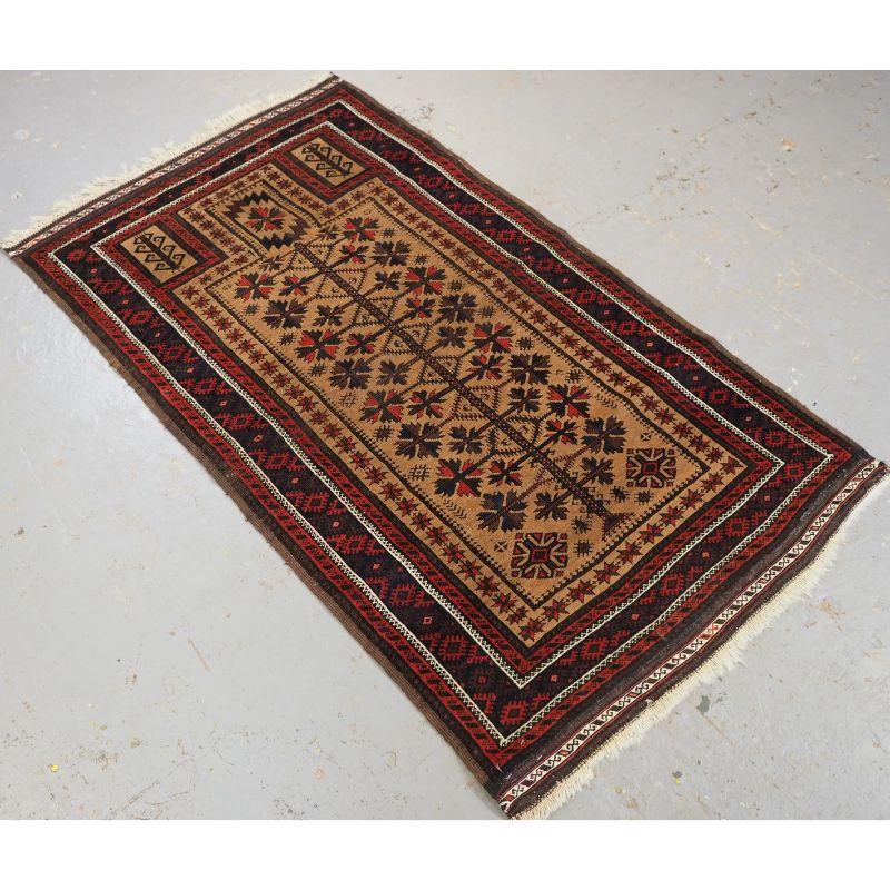 Antique Baluch camel ground prayer rug a design that is typical of the Sarakh's Baluch of Khorasan.

The rug has a well drawn tree of life design and has excellent colour, the camel wool ground is very soft. The rug retains the original banded