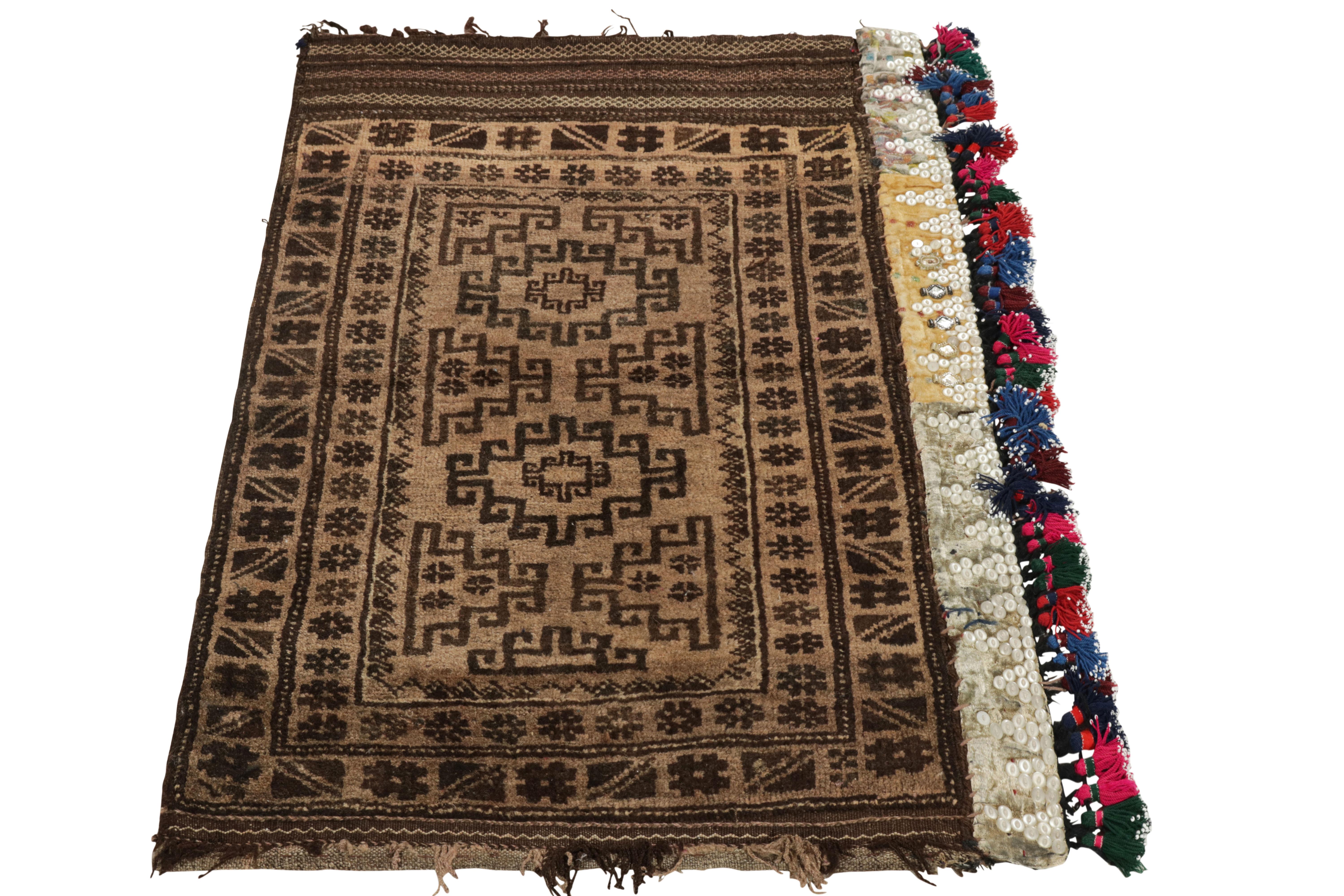 Connoting nomadic sensibilities of Baluchistan, a 3x4 antique Persian Baluch rug originating circa 1920-1930. The tribal style displays a well defined geometric pattern in light brown & charcoal black concluding to sporadic shag pile across