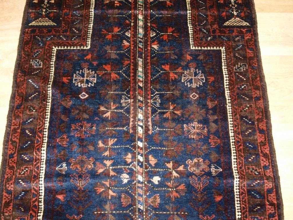 Antique Baluch blue ground prayer rug with 'tree of life' design
Late 19th century

A good blue ground Baluch prayer rug with tree of life design to the field The hand placements also contain a tree design The main border is of a repeat leaf