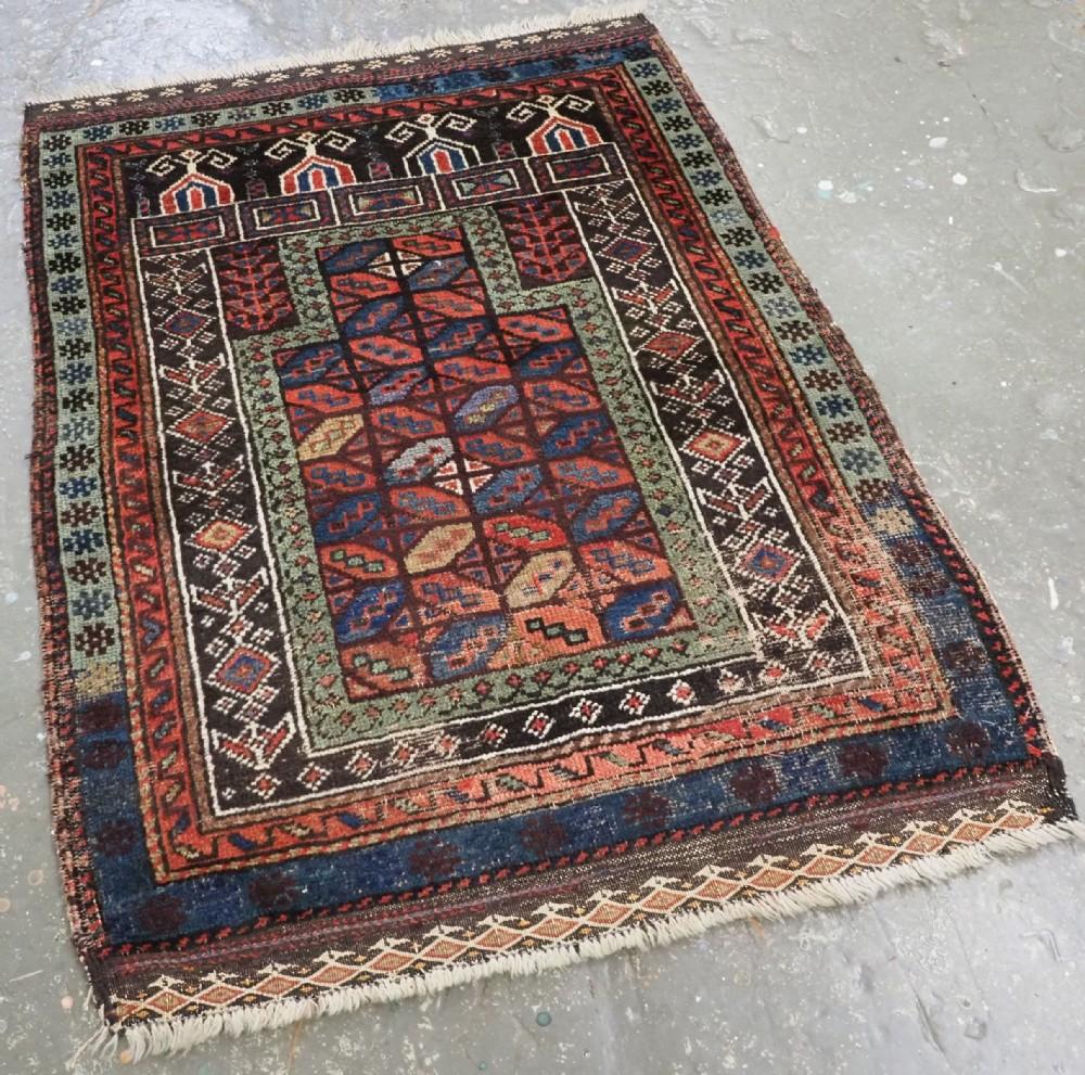Antique Baluch prayer rug of scarce form, attributed to the 'Baluch of Turkestan' by Craycraft
Circa 1880

A scarce and colourful Baluch rug, the central panel is of the well known 'tile' design Other design elements are found in Afghan Sistan