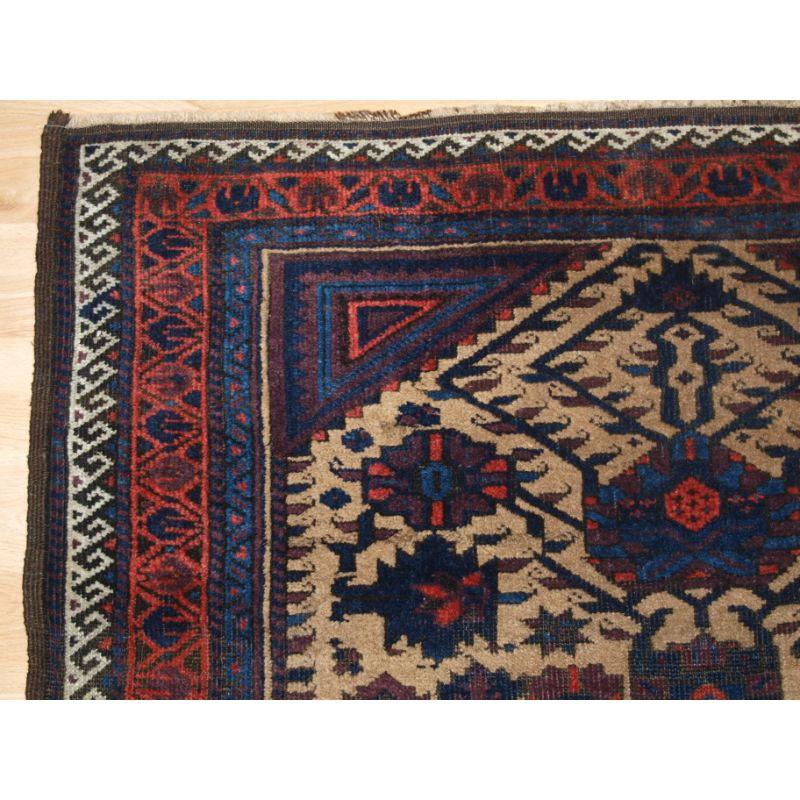 Antique Baluch rug, these Baluch rugs are known as Arab Baluch from the Ferdows region..

The rug has a traditional design unique to this region, the floral design is on a camel ground.

The rug is in good condition with even wear and medium