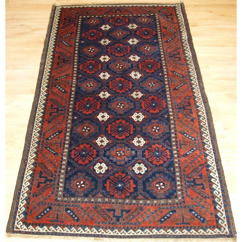 Antique Baluch rug from Khorassan region of Eastern Persia with a well drawn mina khani lattice design.

A good Baluch rug with a diamond lattice design with mina khani (many flowers) type floral design, surrounded by the large boat border. The