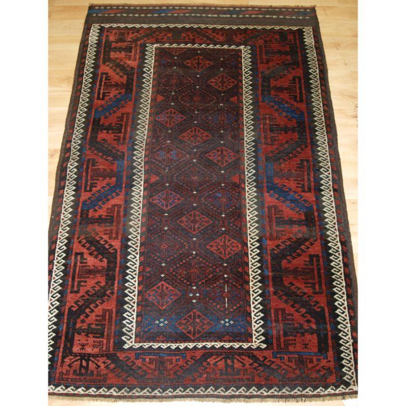 Antique Baluch rug from Western Afghanistan / Eastern Persia. A Baluch rug with outstanding colour with a superb large scale boat border.

A superb Baluch rug with a diamond lattice design to the narrow field.

Surrounded by the large boat