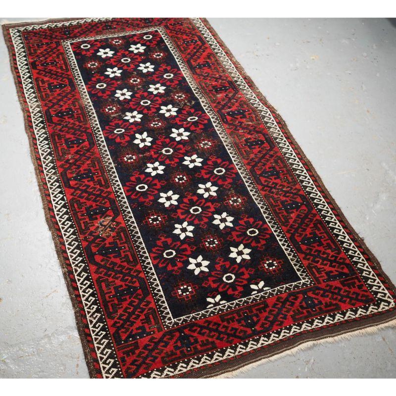 Antique Baluch rug from Western Afghanistan / Eastern Persia. A Baluch rug with a mina khani design on a dark indigo blue field.

A Baluch rug with a mina khani type floral design, surrounded by the large boat border. The small white flowers stand