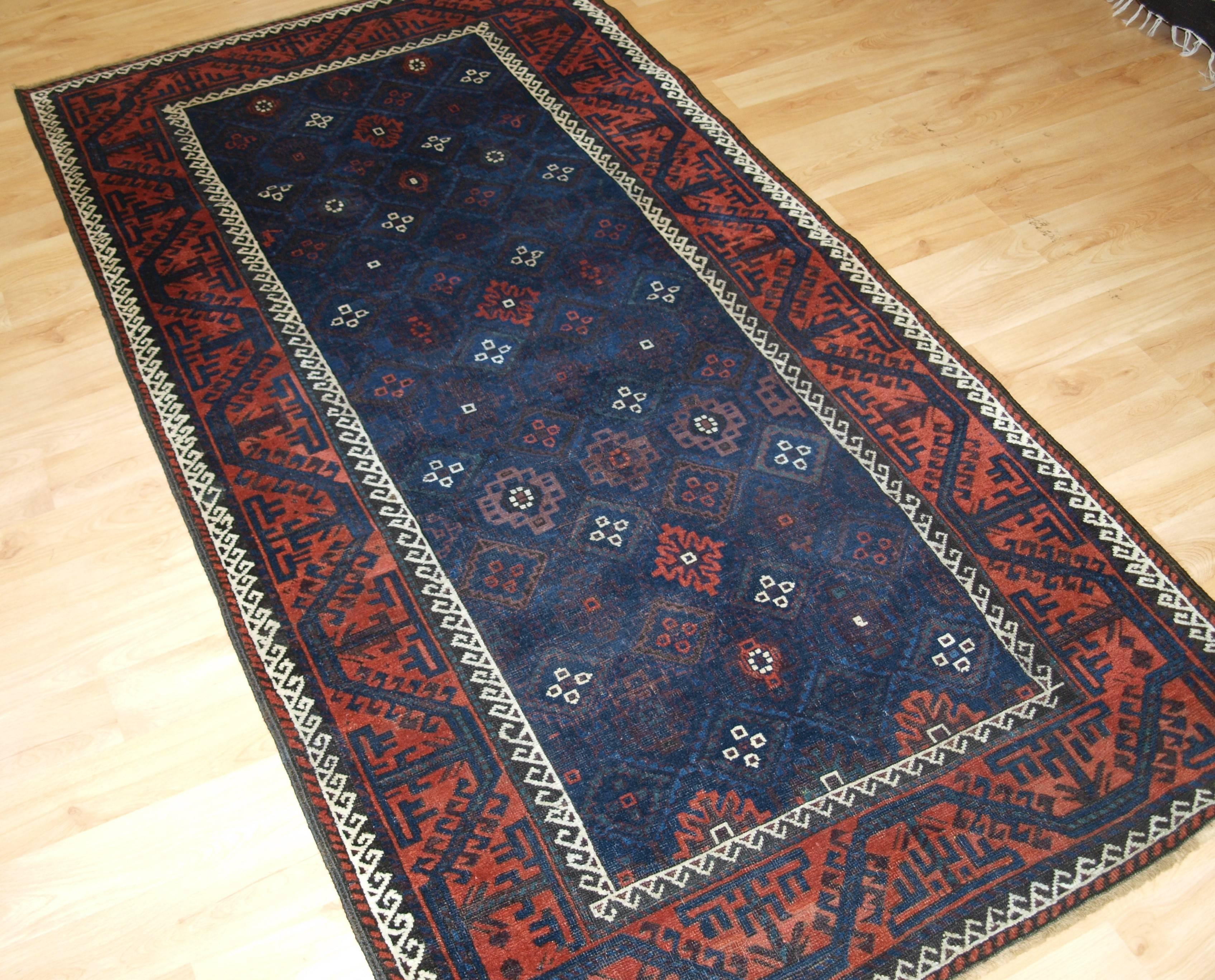 Size: 6ft 11in x 3ft 8in (212 x 112cm).
Antique Baluch rug from Western Afghanistan / Eastern Persia. A Baluch rug with a very unusual lattice design in blue.
circa 1880.
A superb Baluch rug with a diamond lattice design with mina khani type