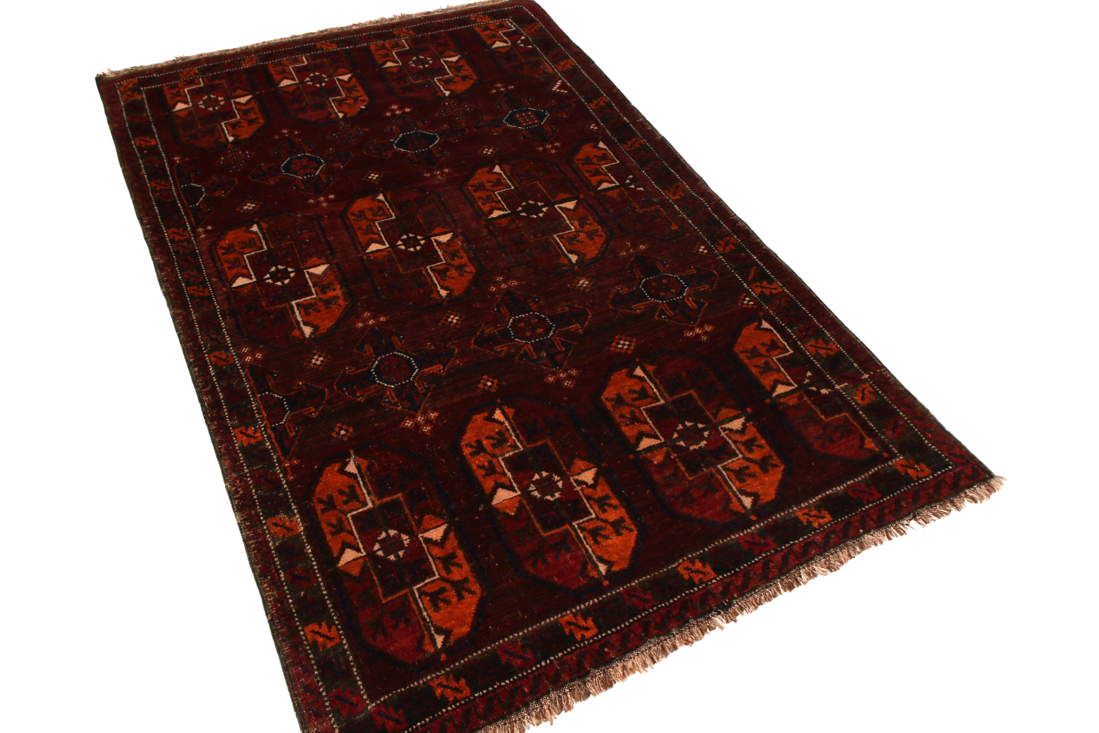 Made with hand knotted wool originating from Persia circa 1910-1920, this antique Baluch rug enjoys one of the richest and sought-after burgundy red colorway hues even among Rug & Kilim’s encompassing antique and vintage rug collection; complemented