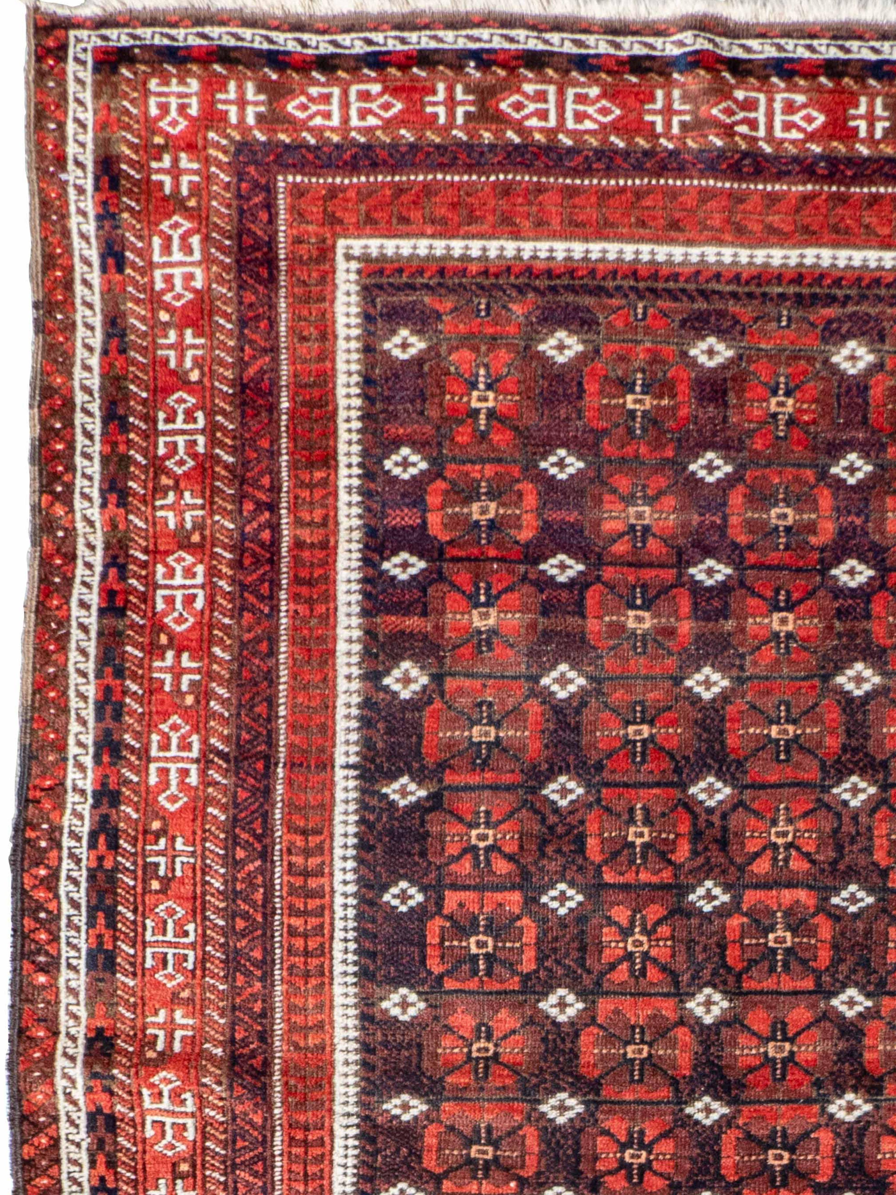 Antique Baluch rug, c. 1900

A finely woven antique Baluch rug from Persia, c. 1900, showcasing the rich tribal artistry of the Baluch weavers. The field is filled with a repeat lattice of traditional Baluch guls in deep madder red and indigo,